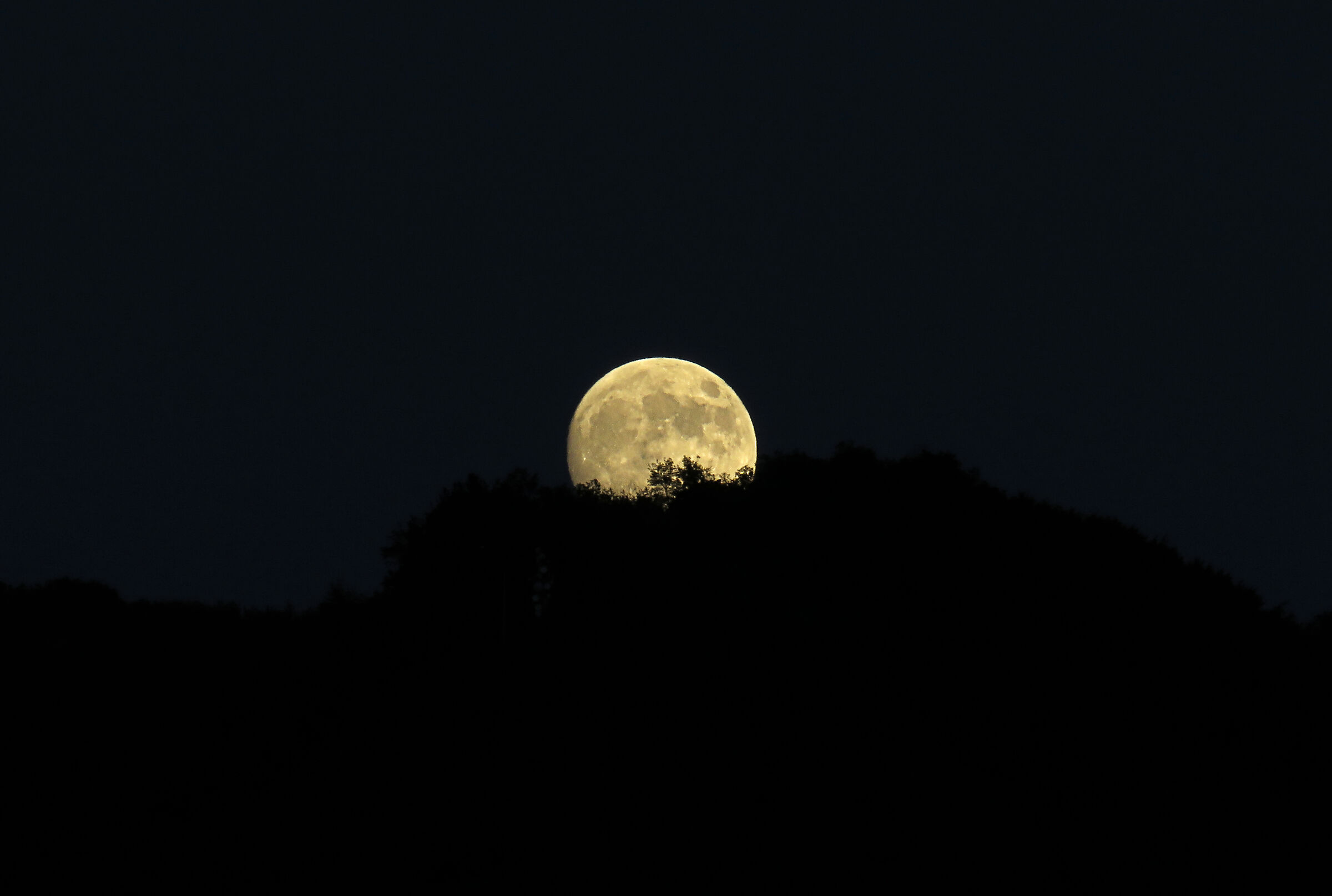 The moon comes out of the mountain