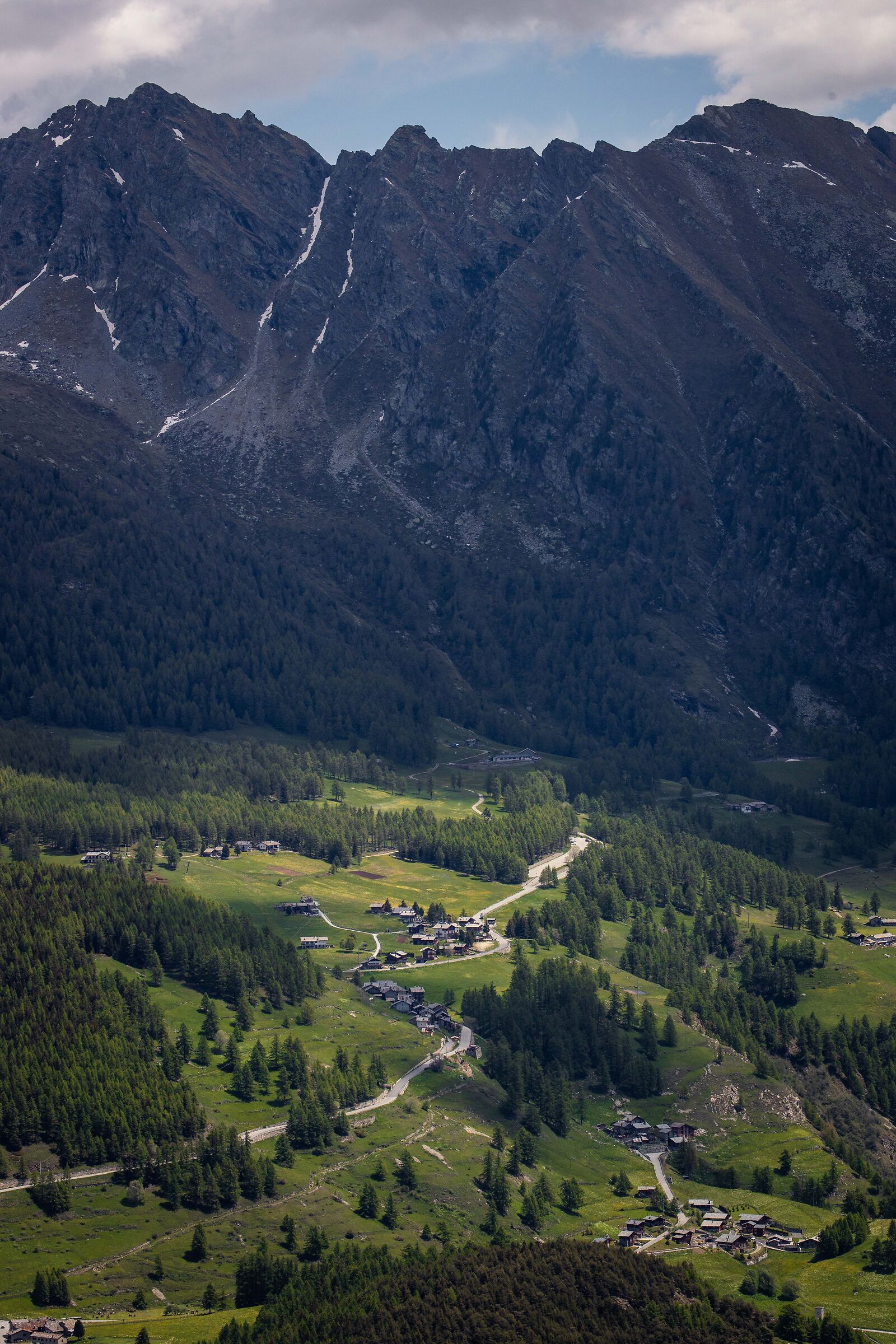 Green villages next to dark mountains