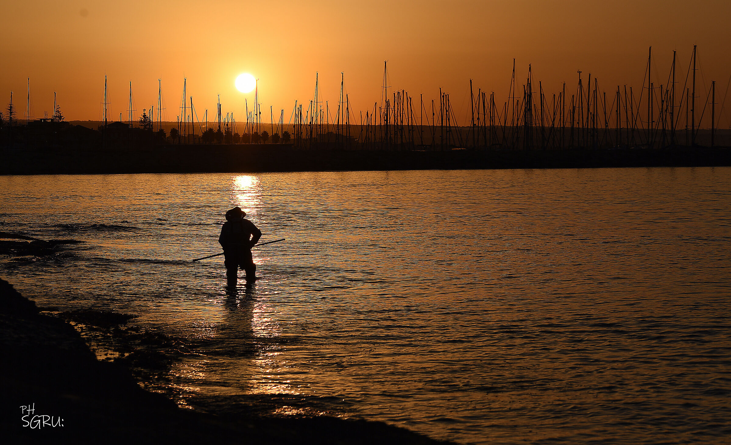 a fisherman at the dawn of the last sun
