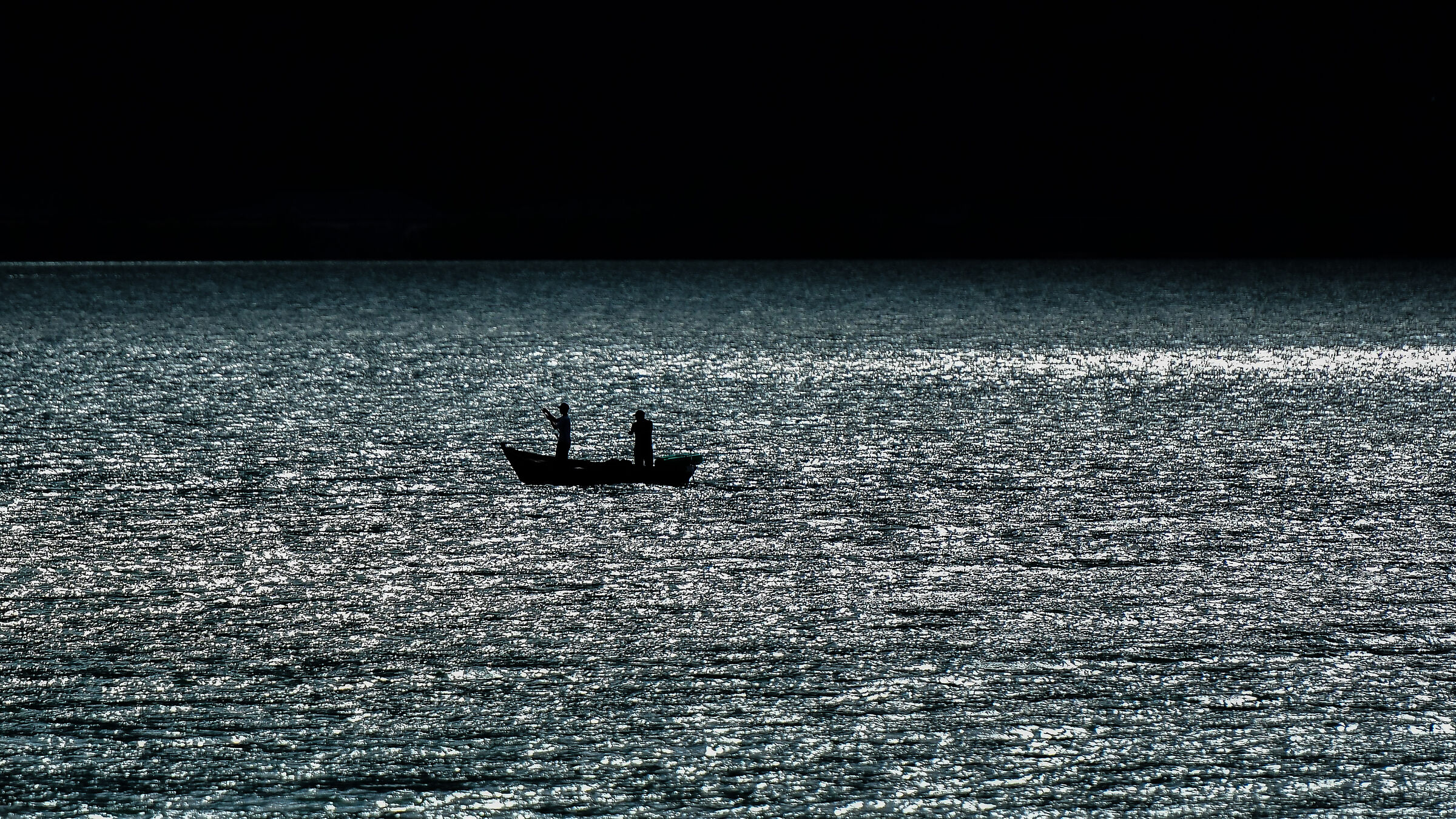 Fishing in the lake at sunset