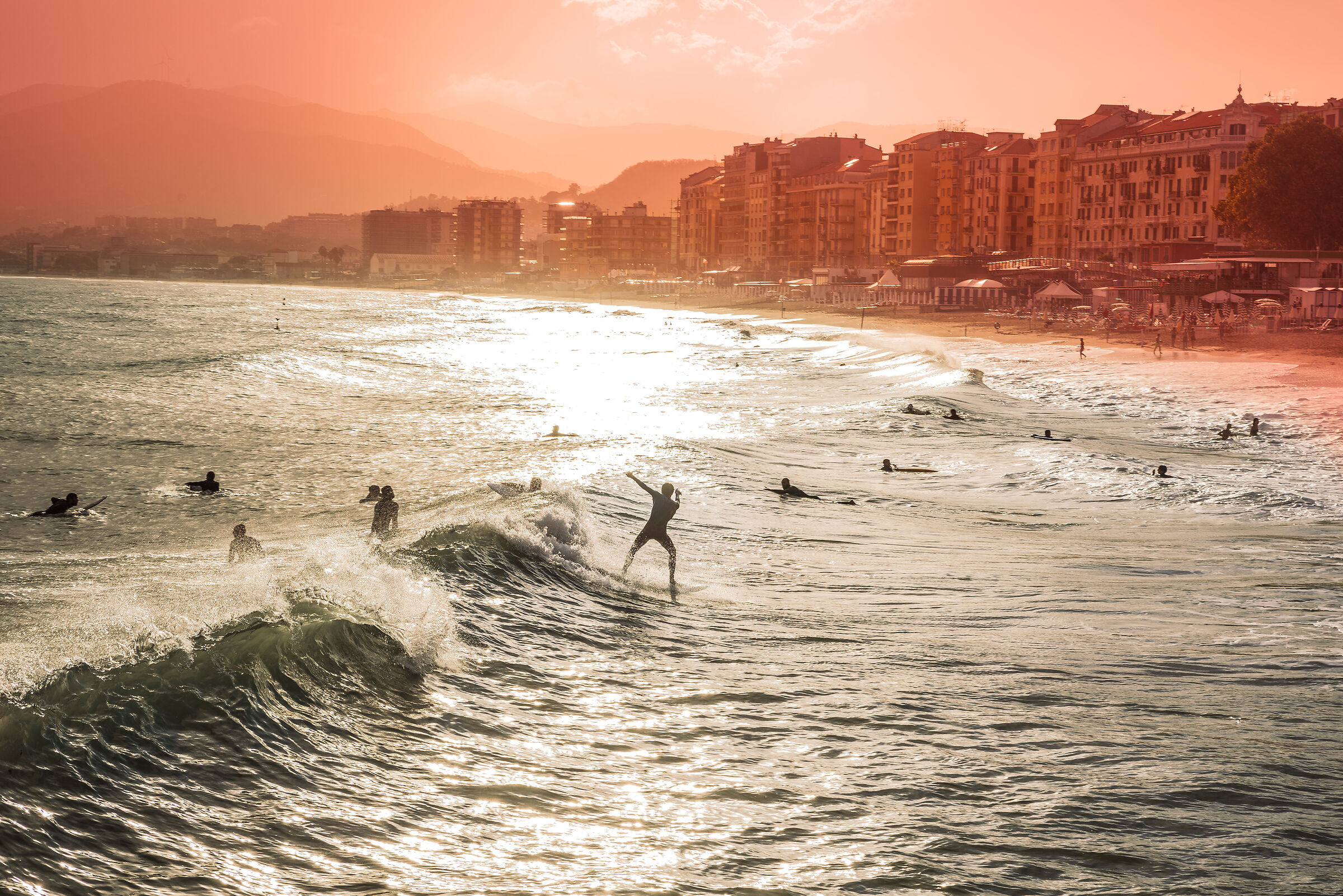 Surfing at sunset in late summer