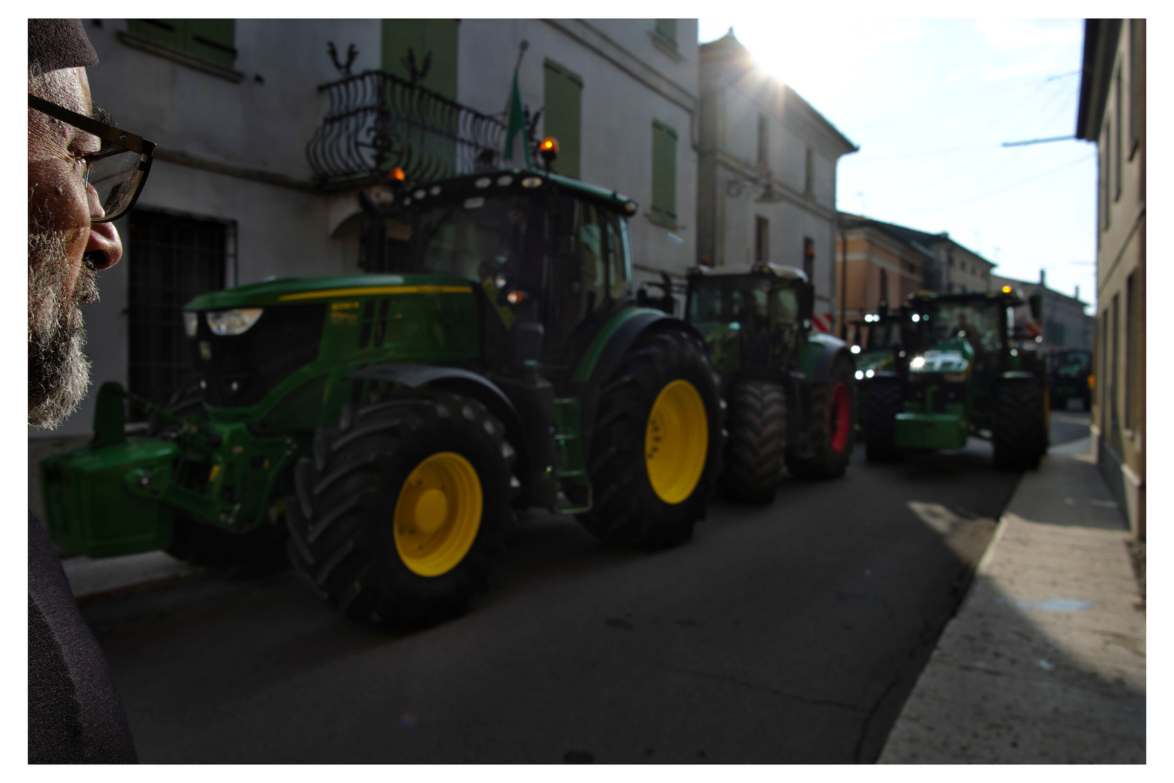 Agricultural tractors in the historic center of Piubega.