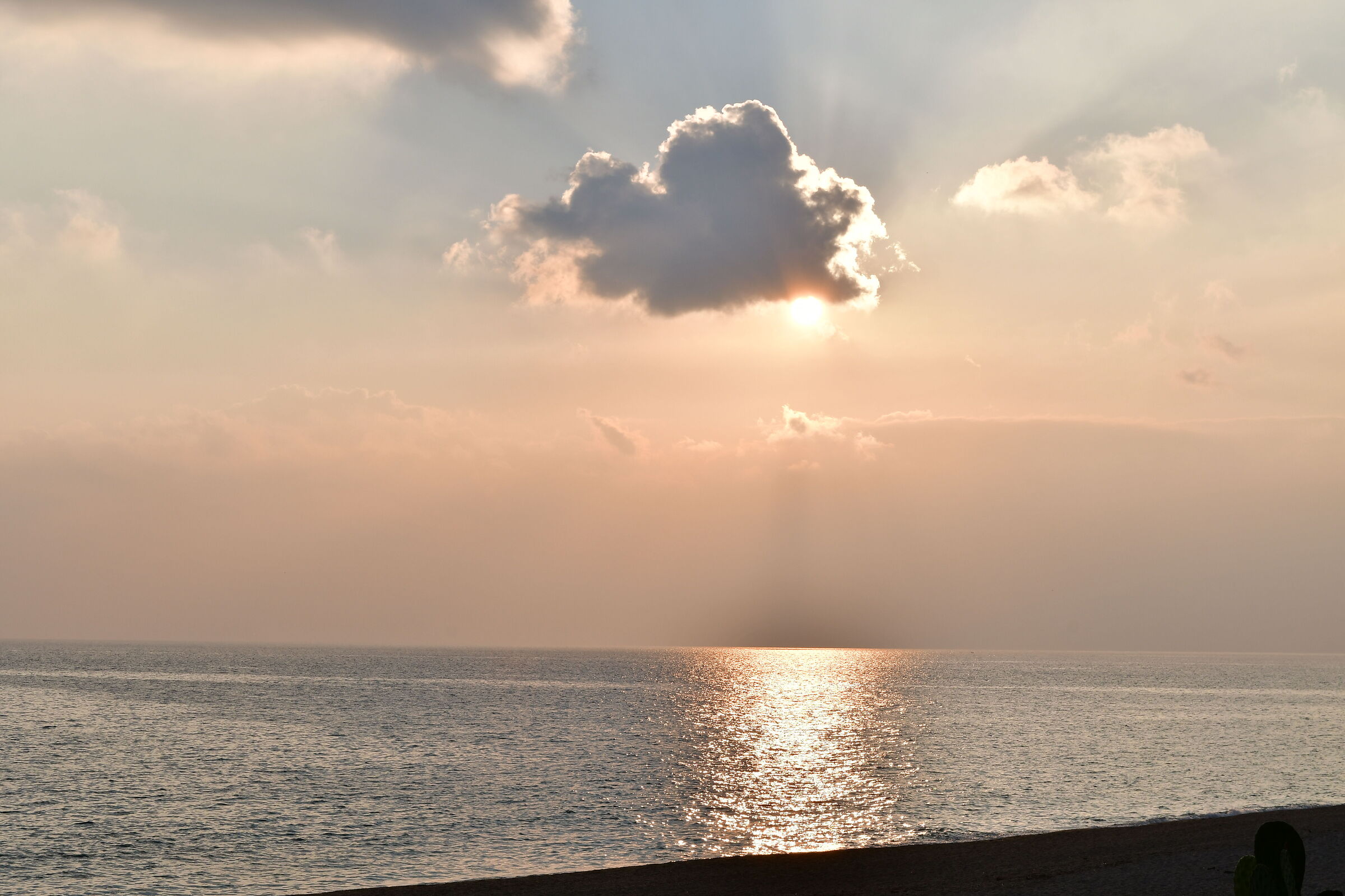 Sunset over the Ligurian Sea between clouds and mist