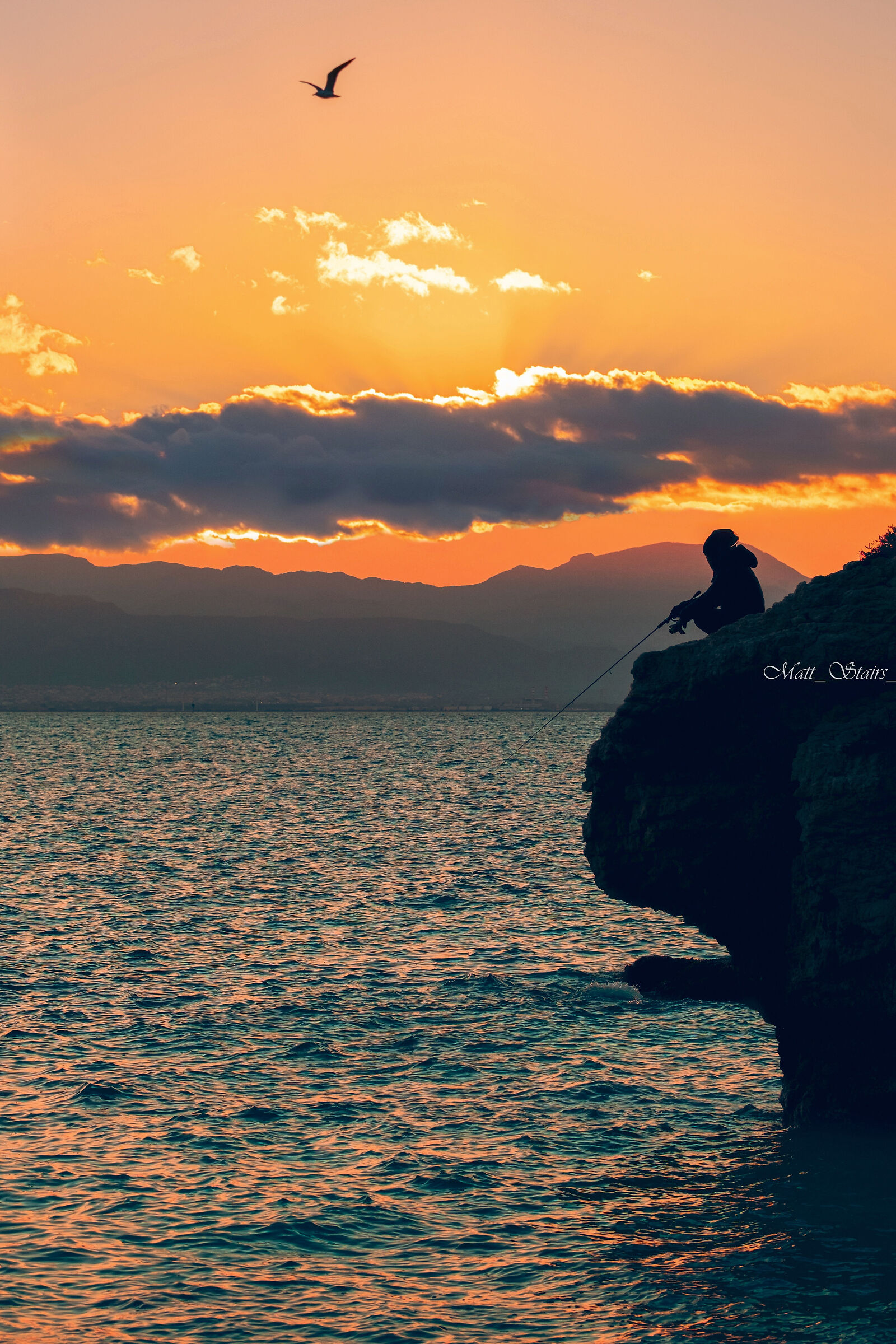 The fisherman in the shade of the last sun