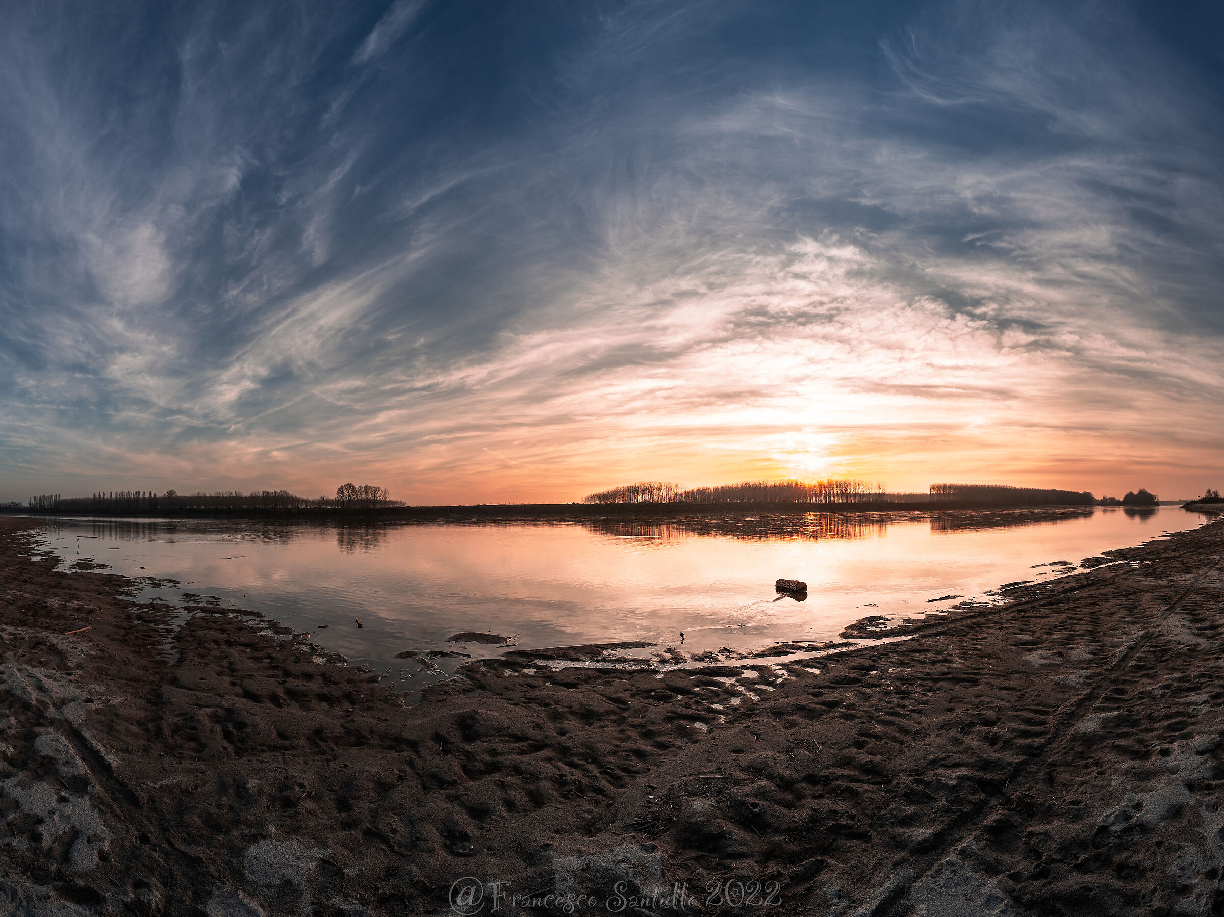 Along the river bank.