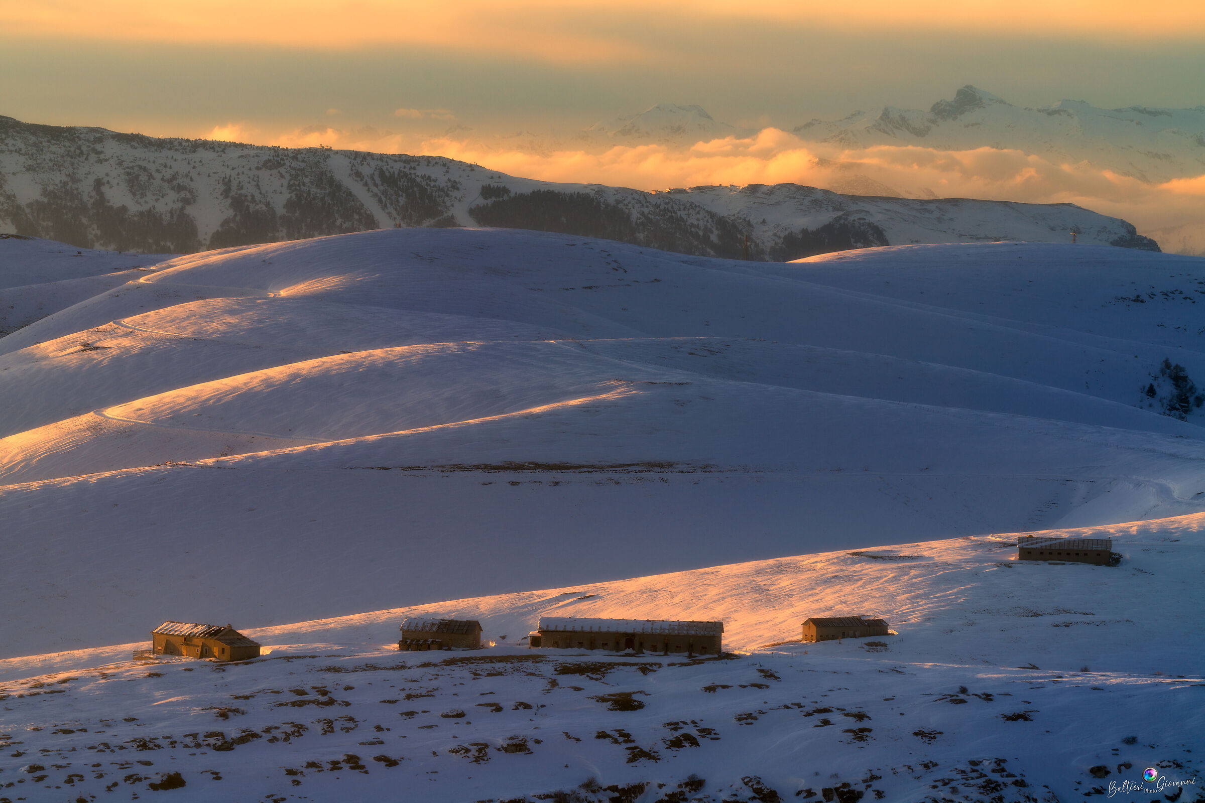 Alpine huts at sunset