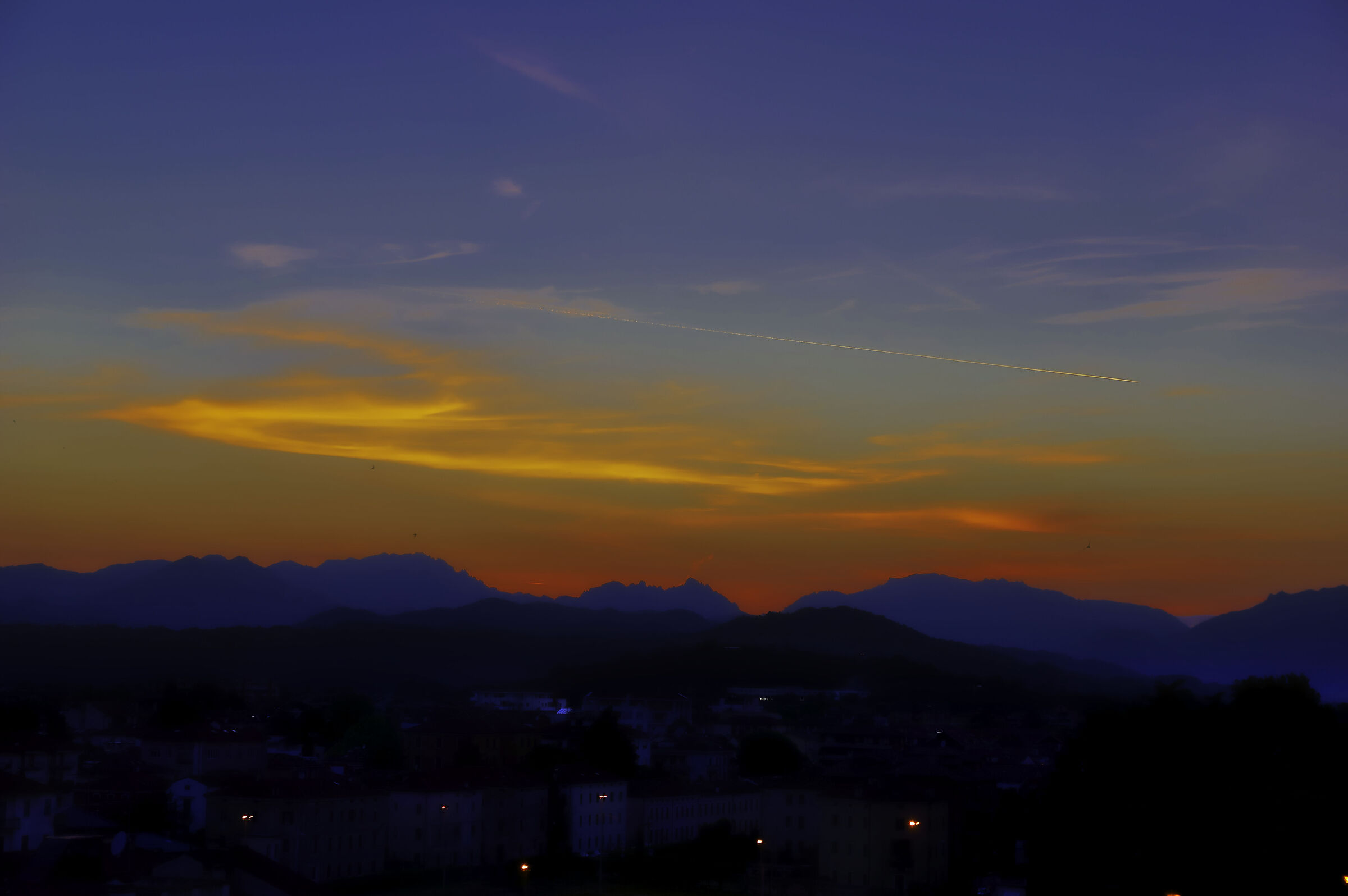 Sunset with airplane wake