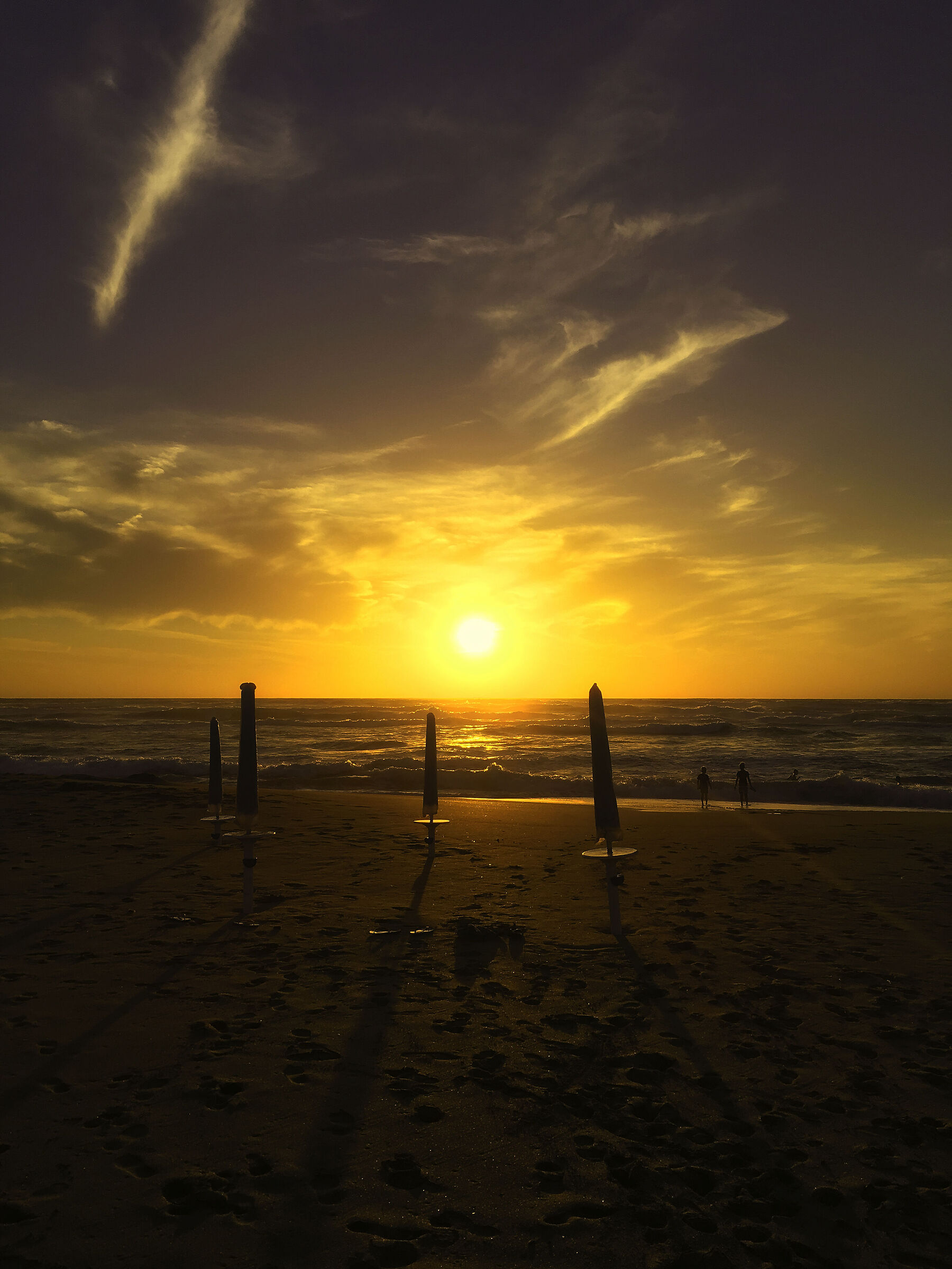 Sunset over the sea with umbrellas