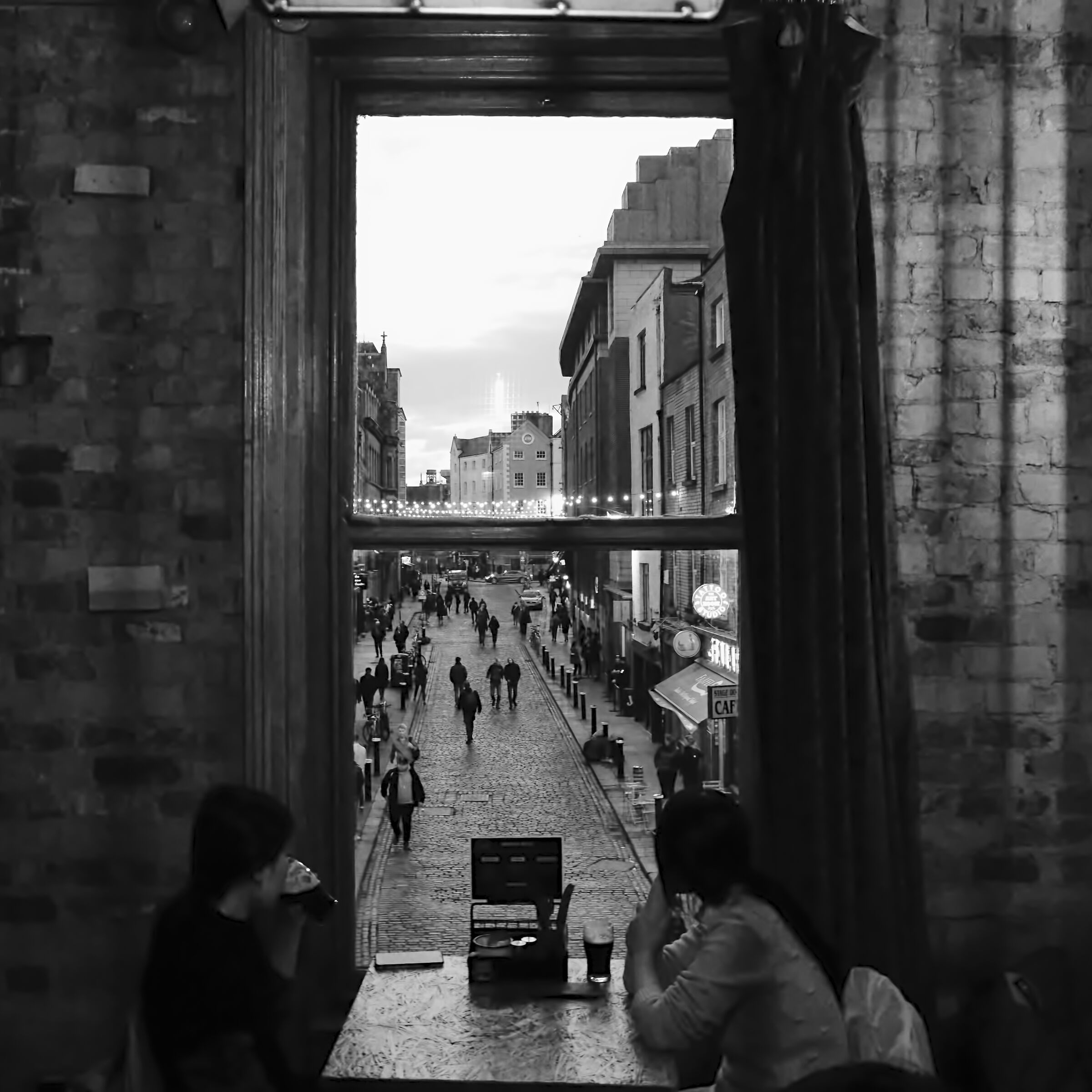 Asian girls at the window of a Dublin pub