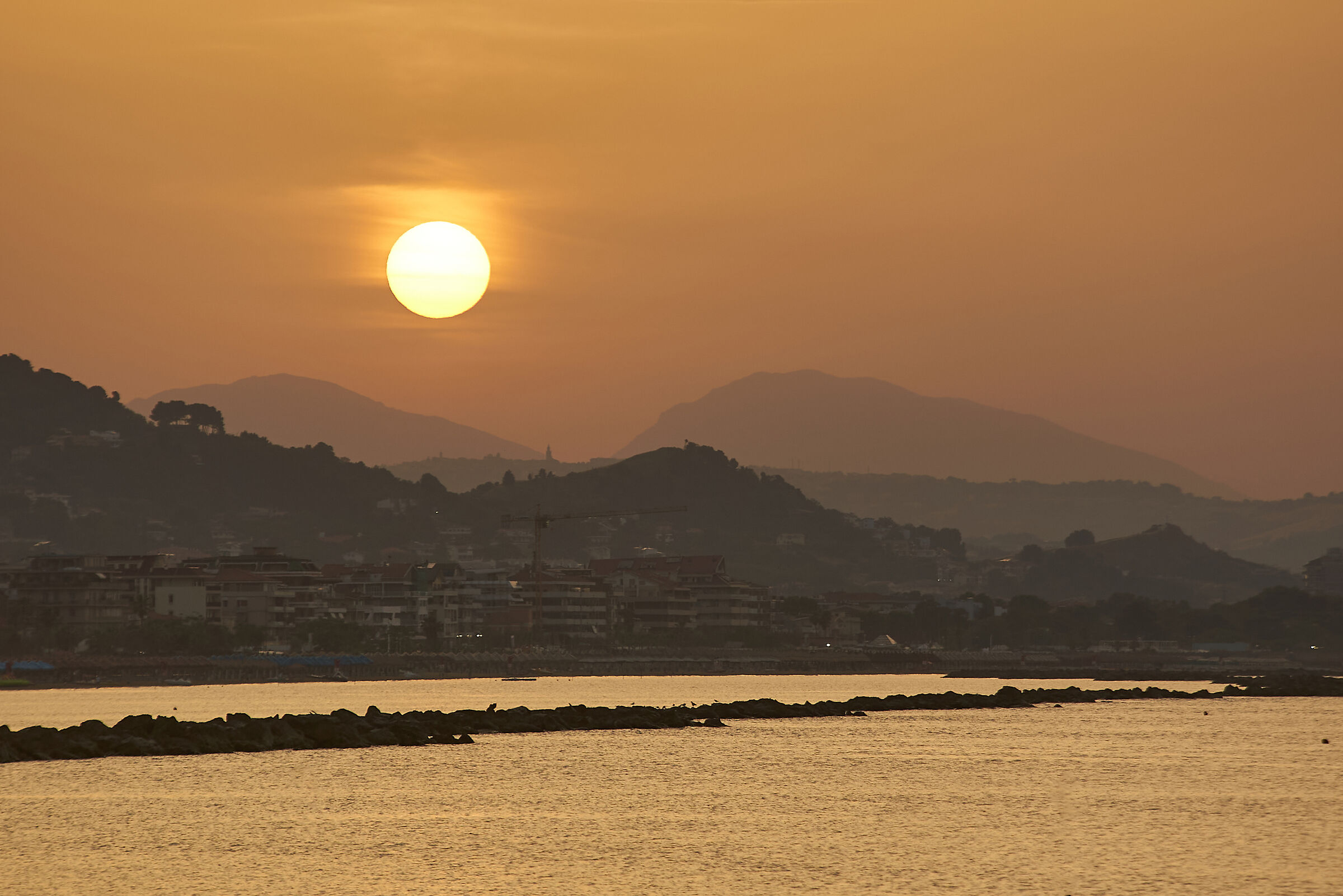 Sunset in the twin mountains at the summer solstice