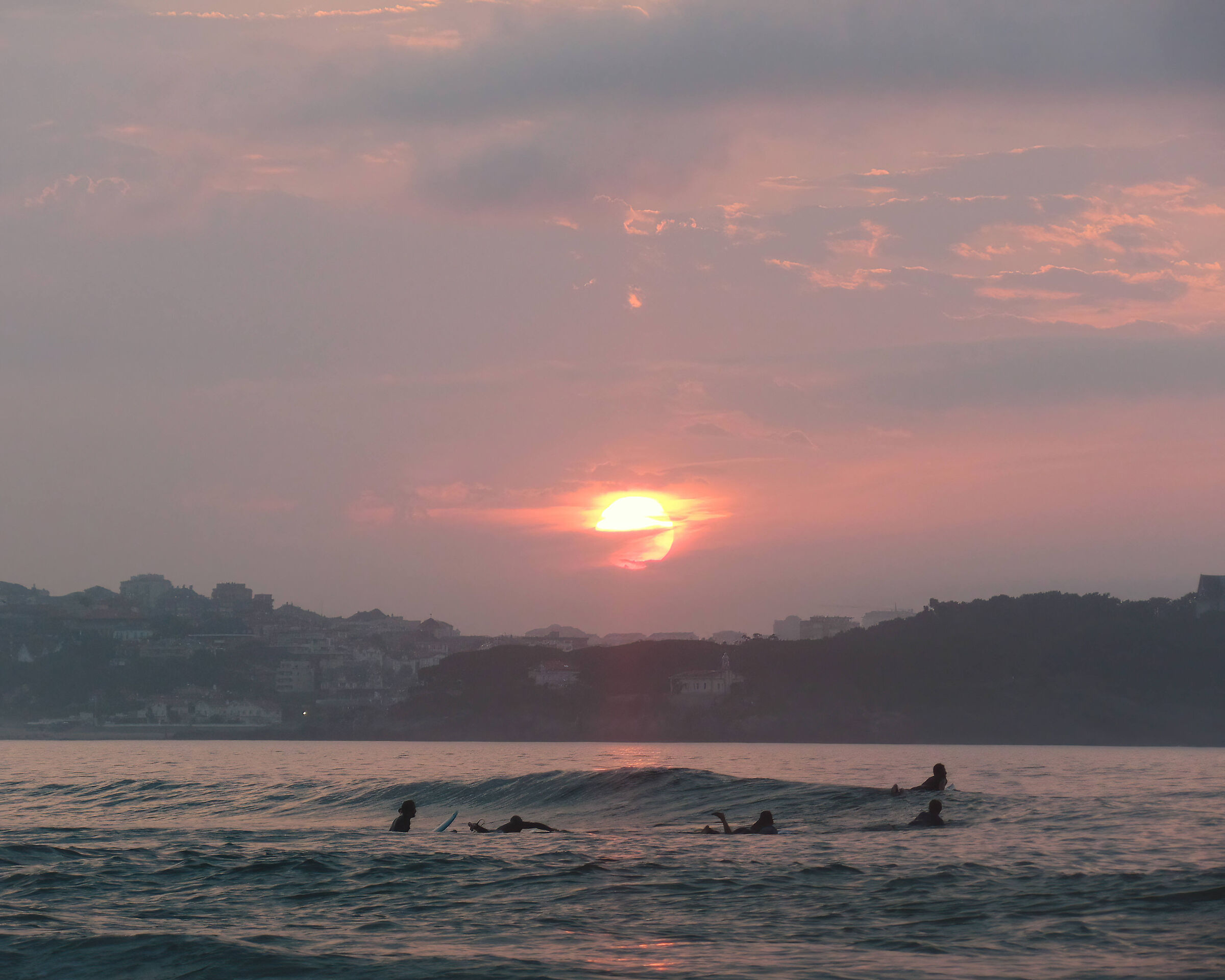 Sunset of fire on surfers