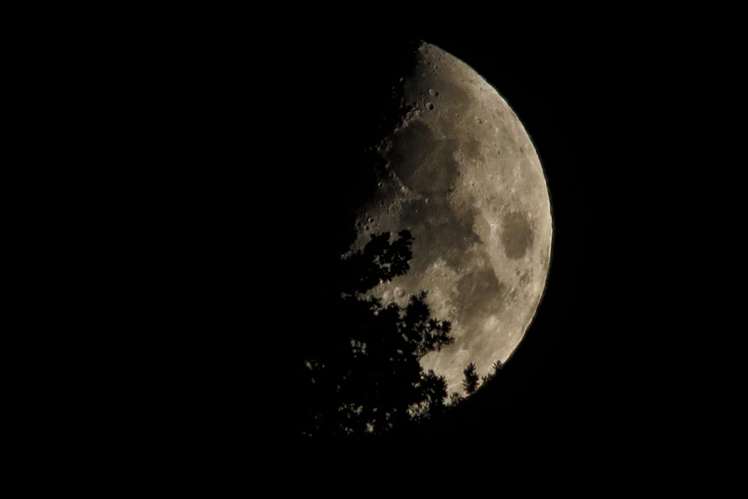Half moon emerges from the mountain