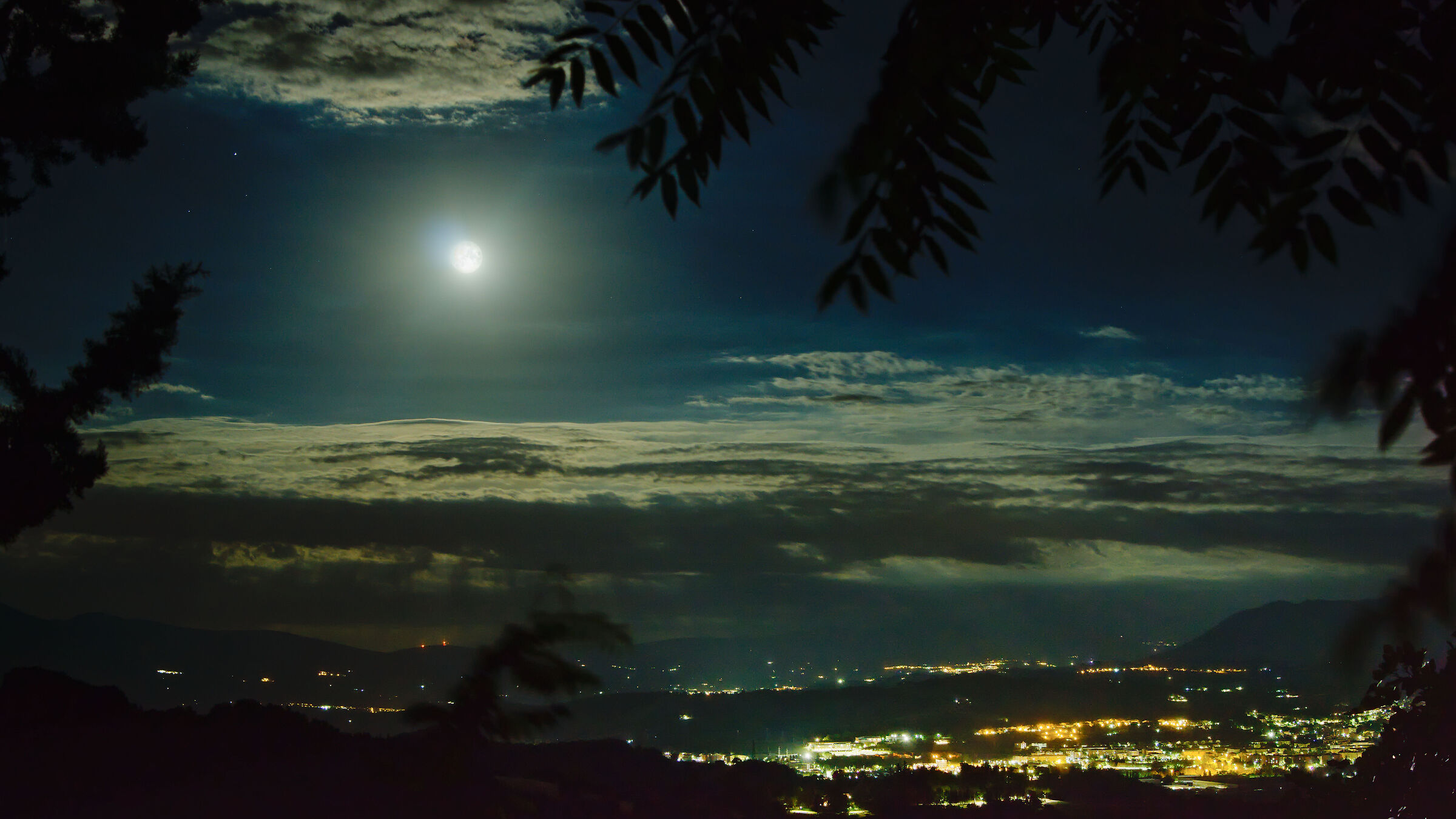 Moon over Fabriano between clouds and fronds