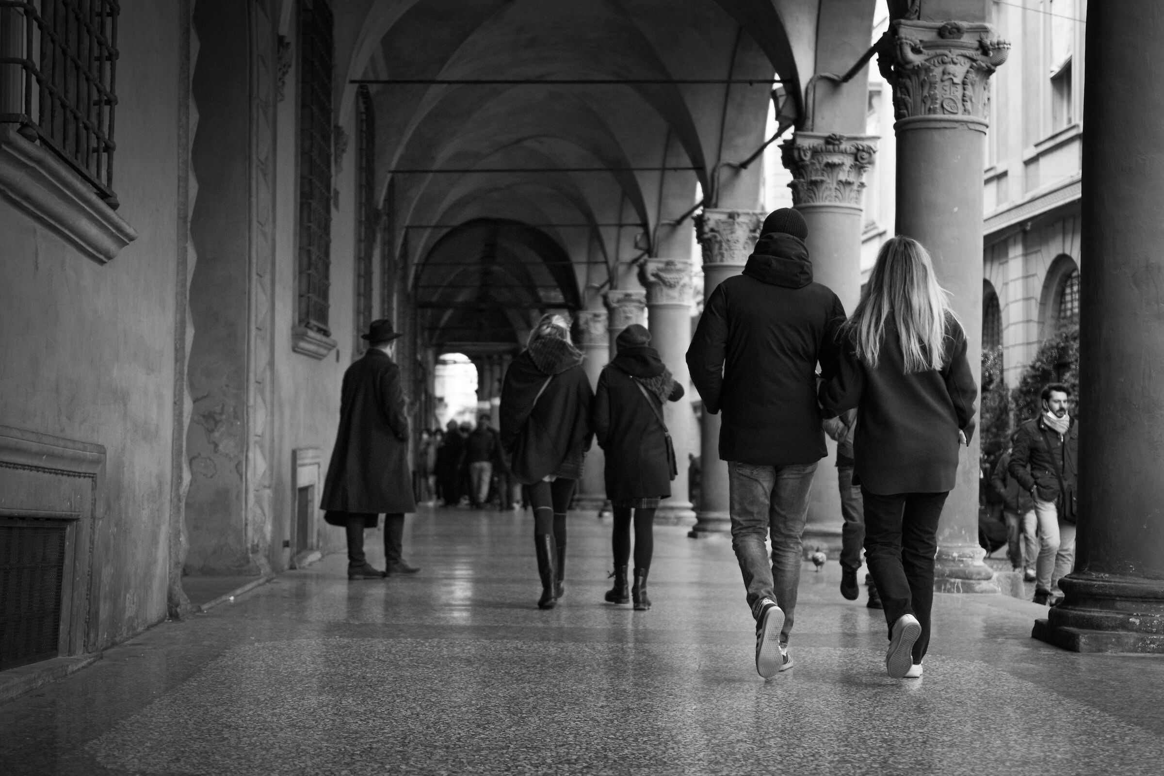 Walking under the arcades of Bologna