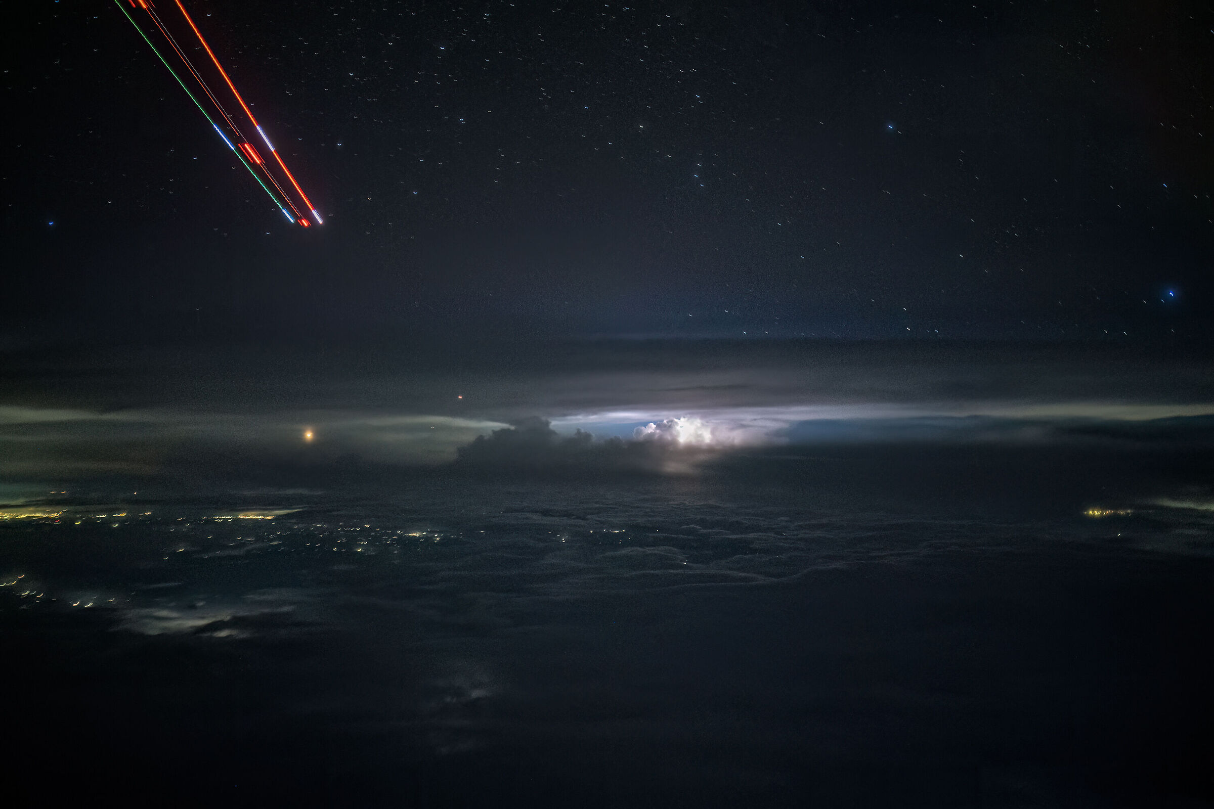 The plane, the stars, the cities and the storm