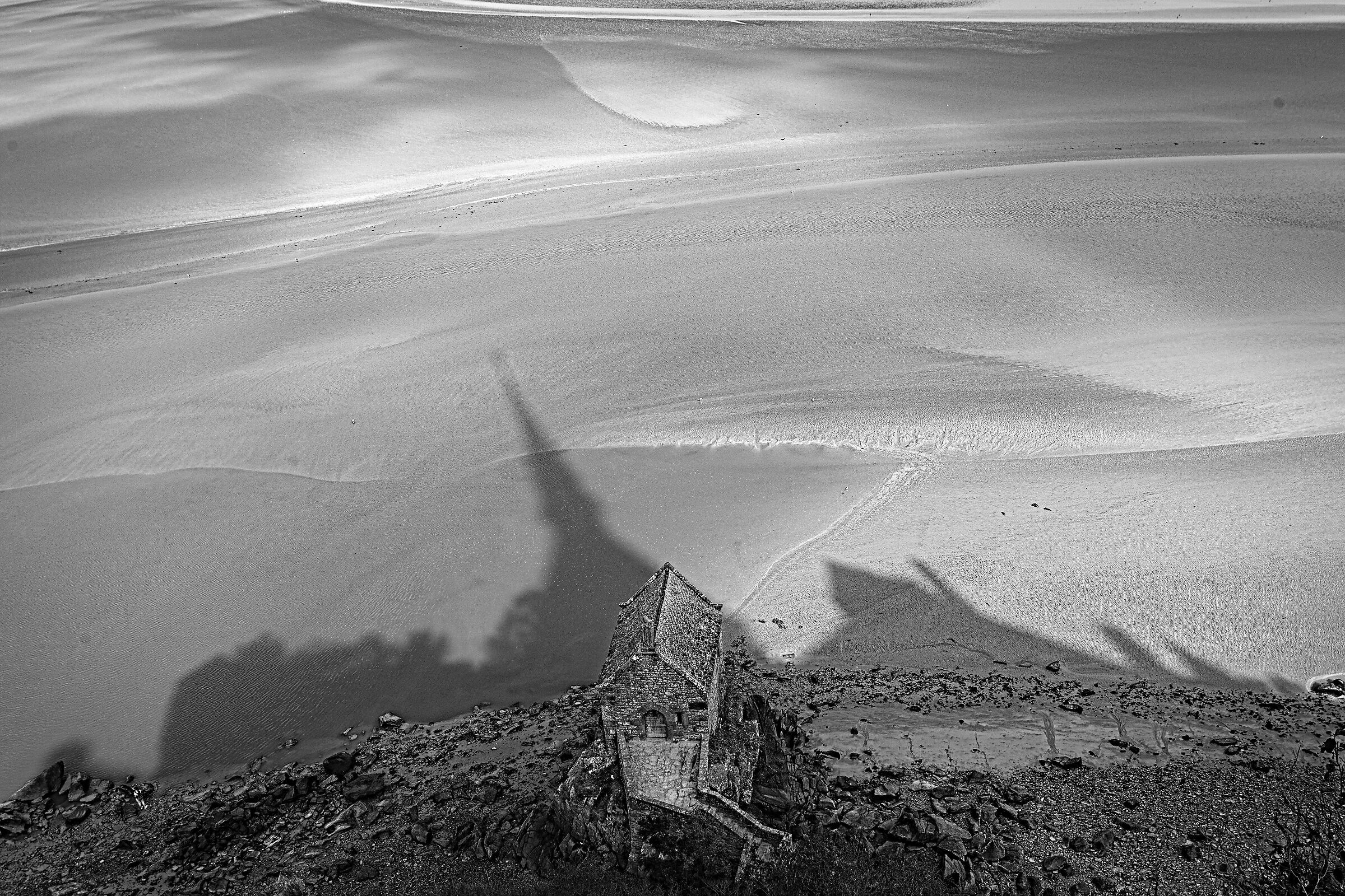 The shadow of the spires of Mont Saint Michel at low tide