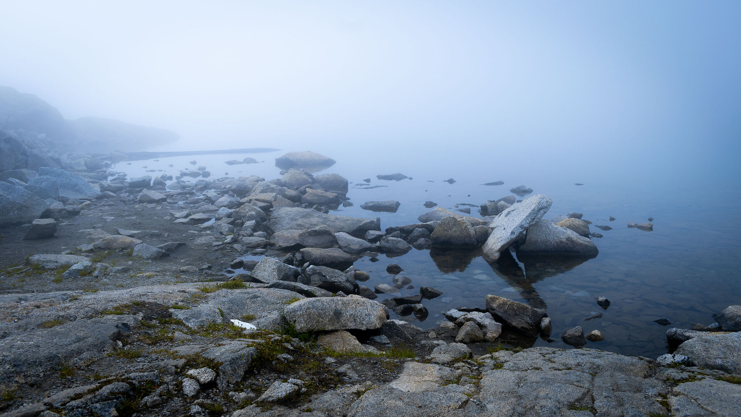 Small lake immersed in fog
