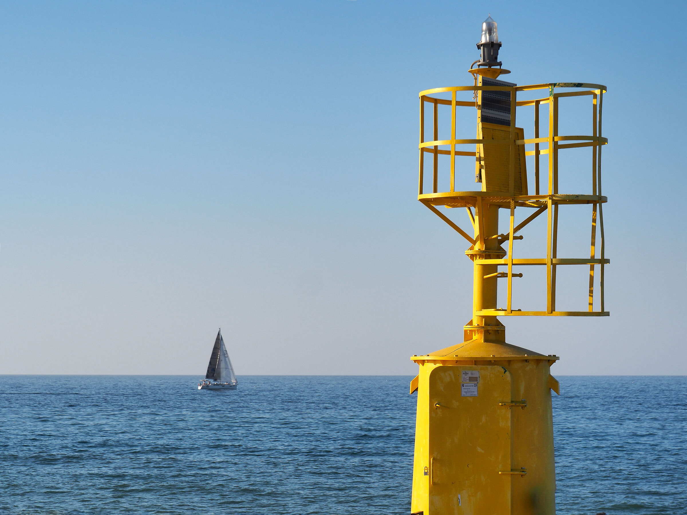 The lighthouse and the sailboat