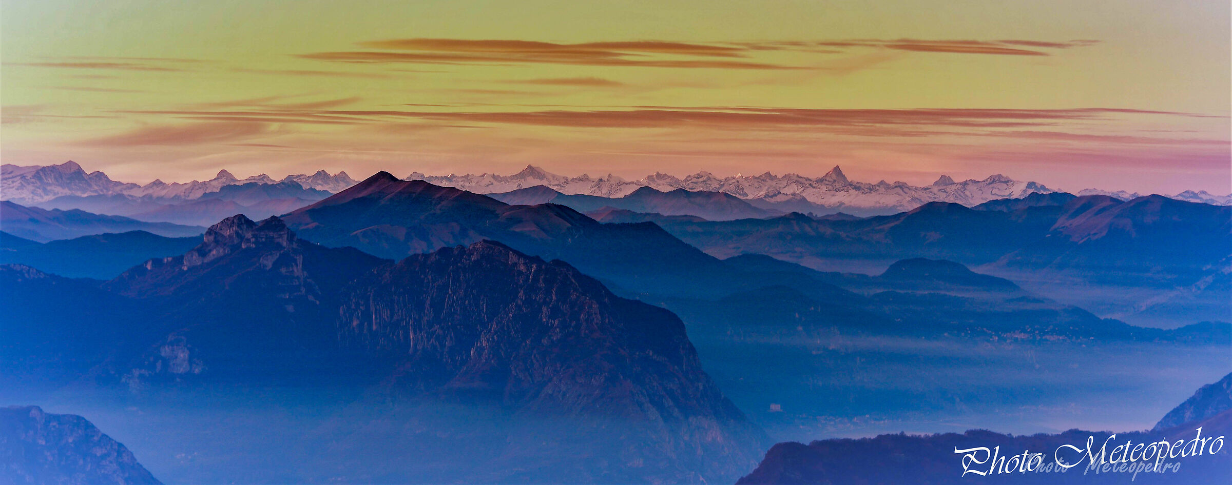 the tops of the mountains emerge from the mist