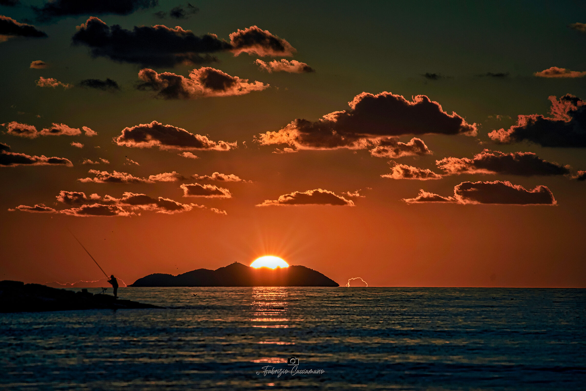 The sun at night hides behind the Gorgona