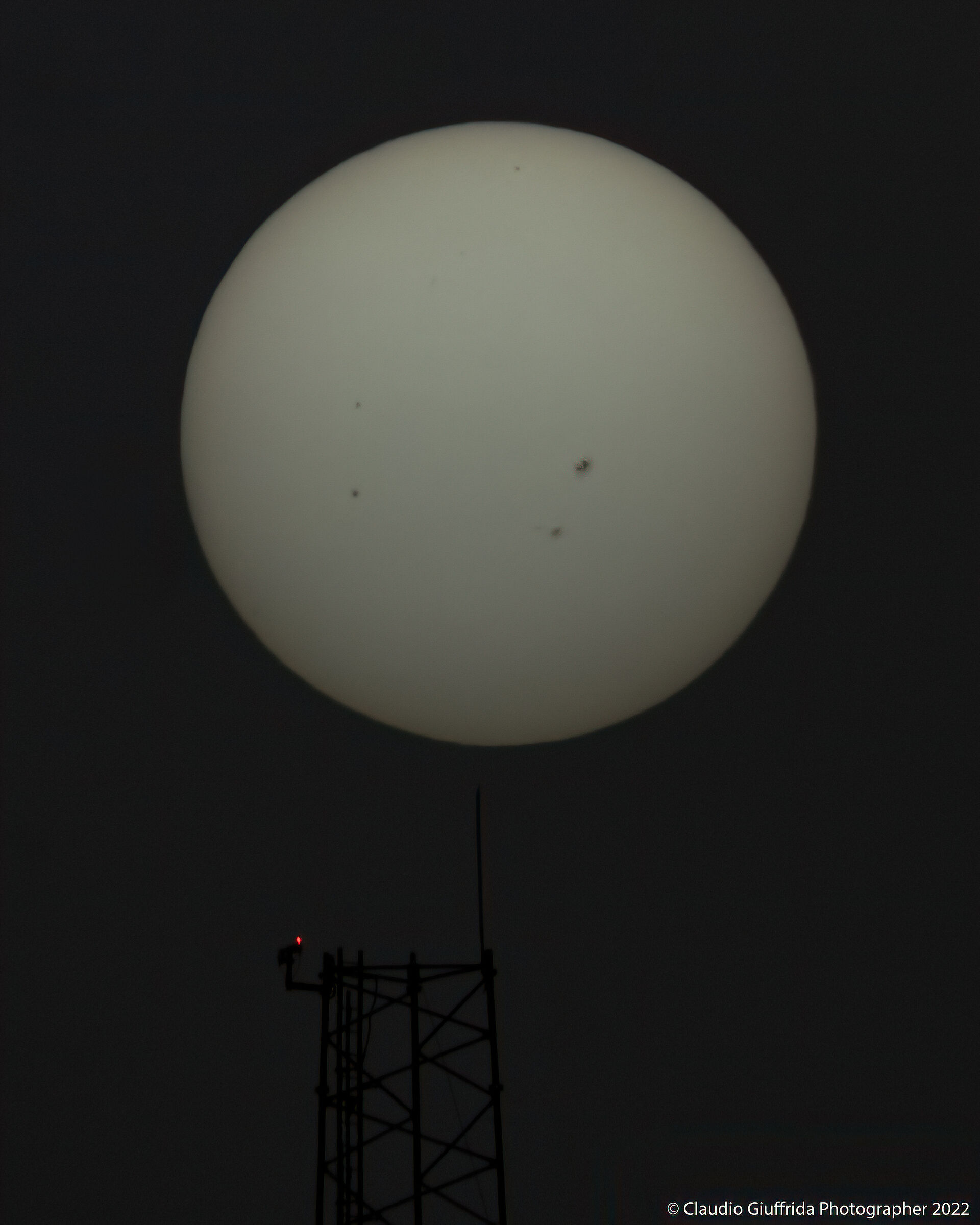 At the tip of a pin.