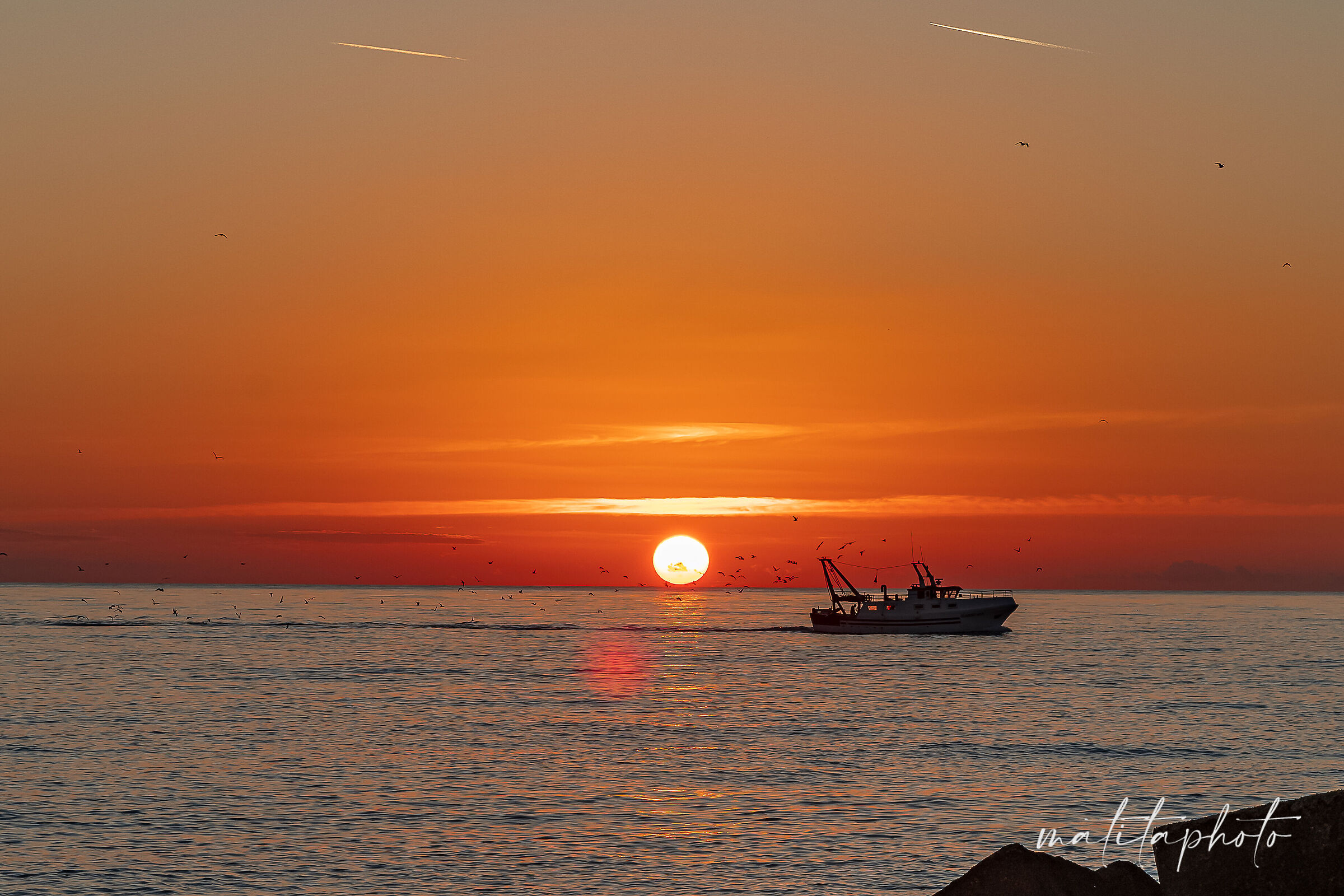 Sunset with fishing boat