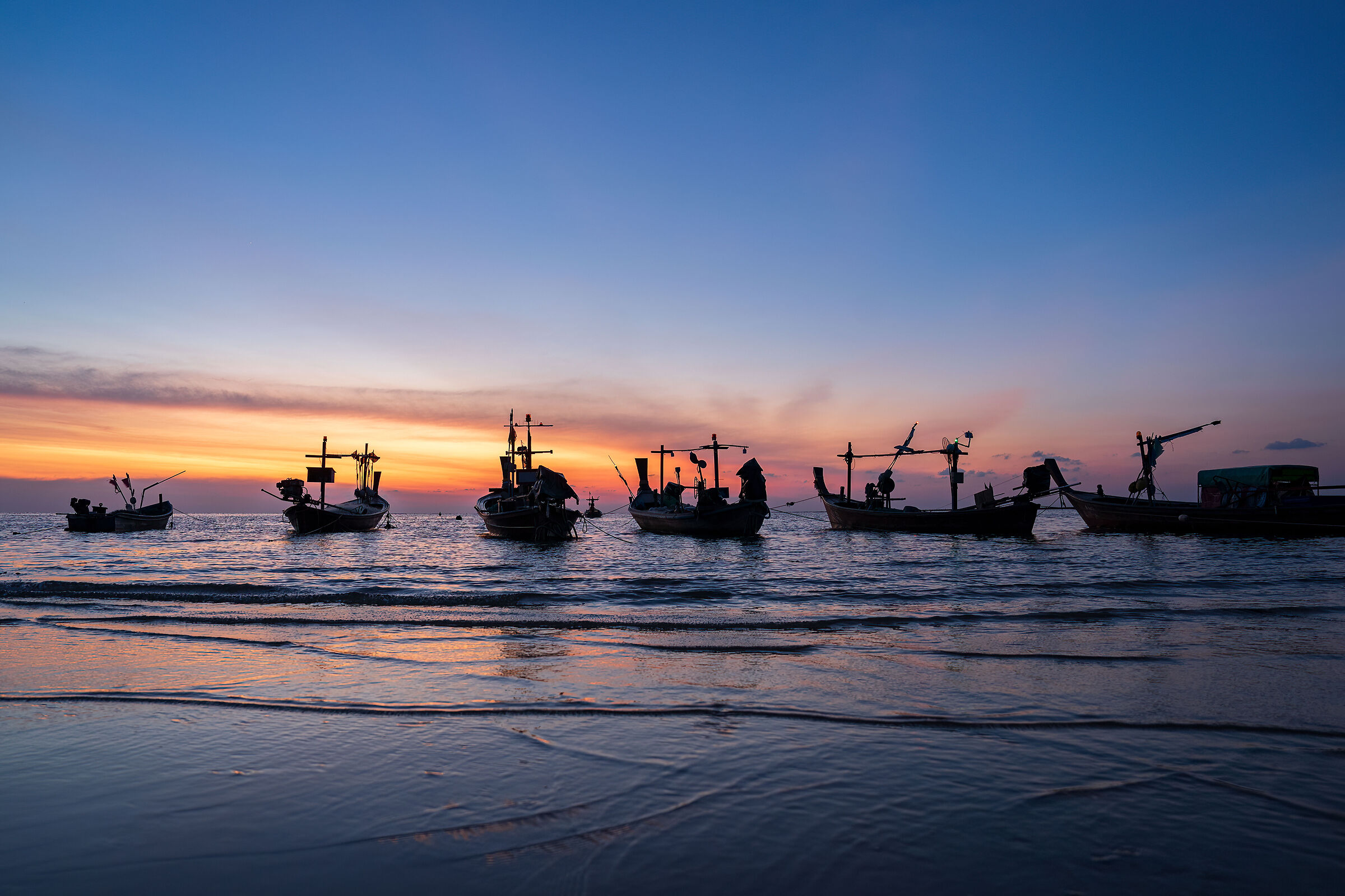Fishing boats at the beginning of the night