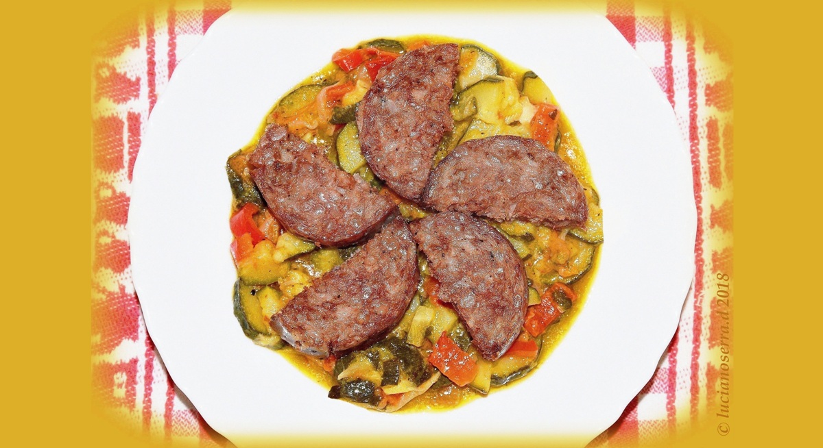 Cotechino on a bed of cooked vegetables