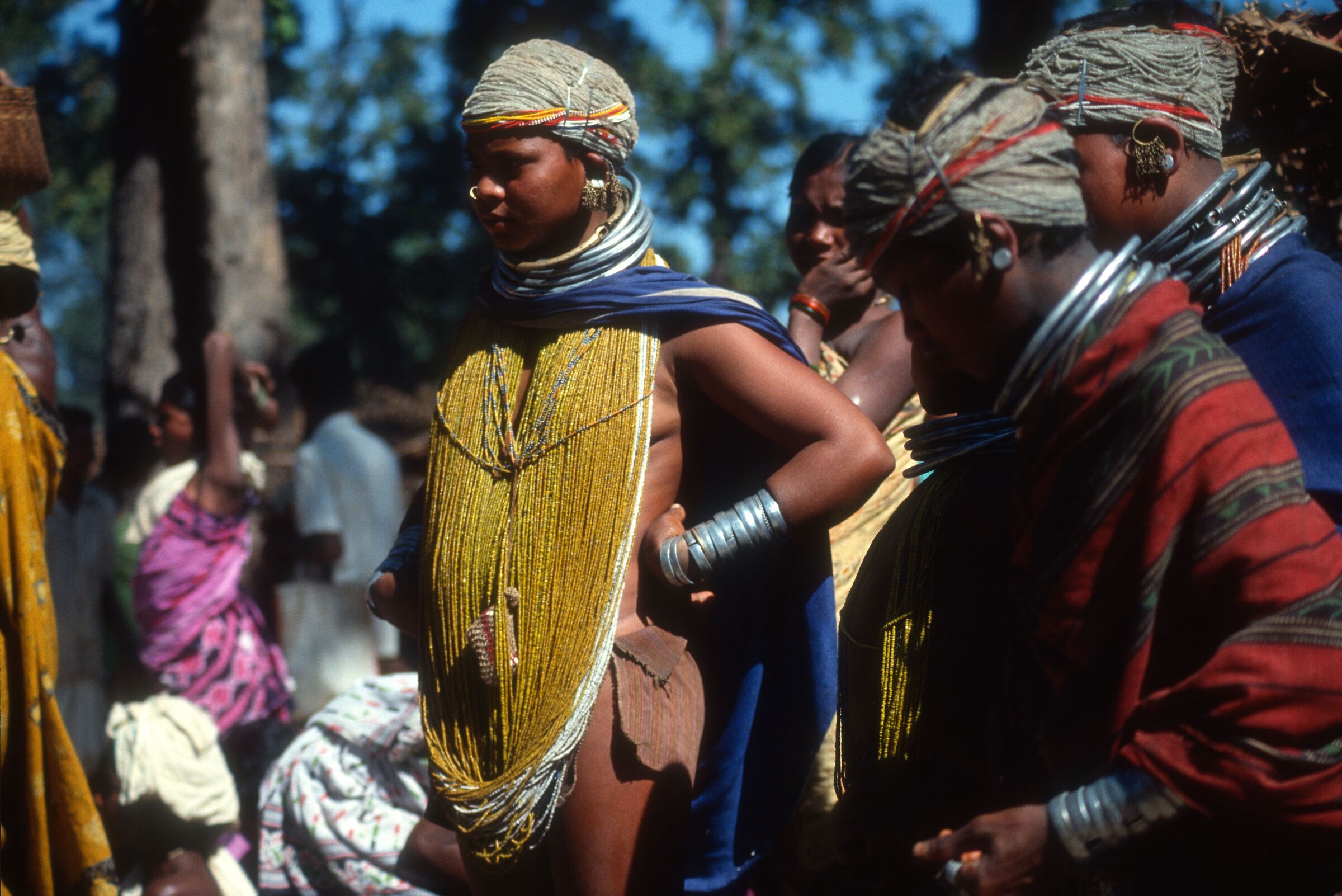 DRESSED IN BEADED NECKLACES