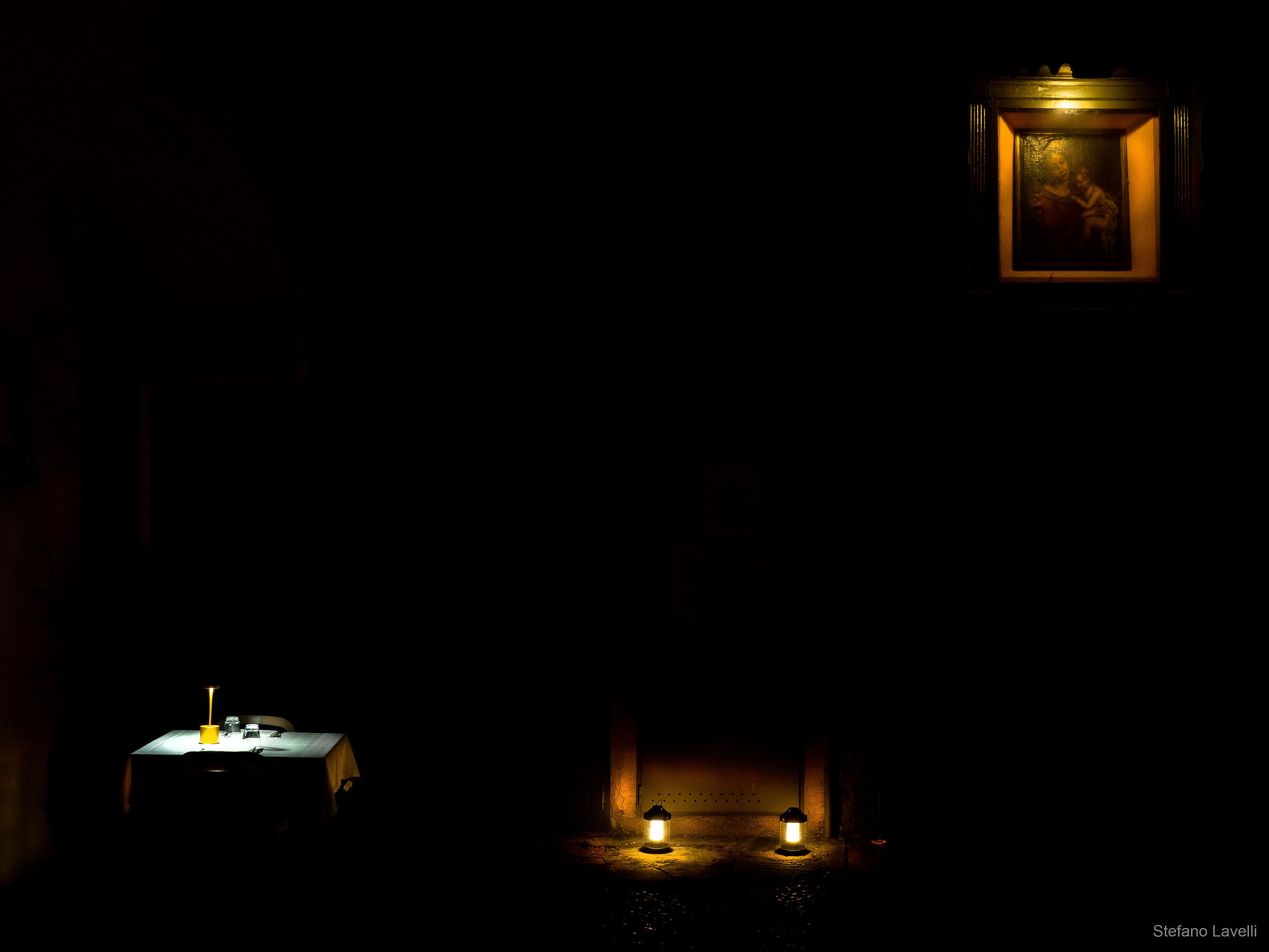 Dark courtyard with set table.