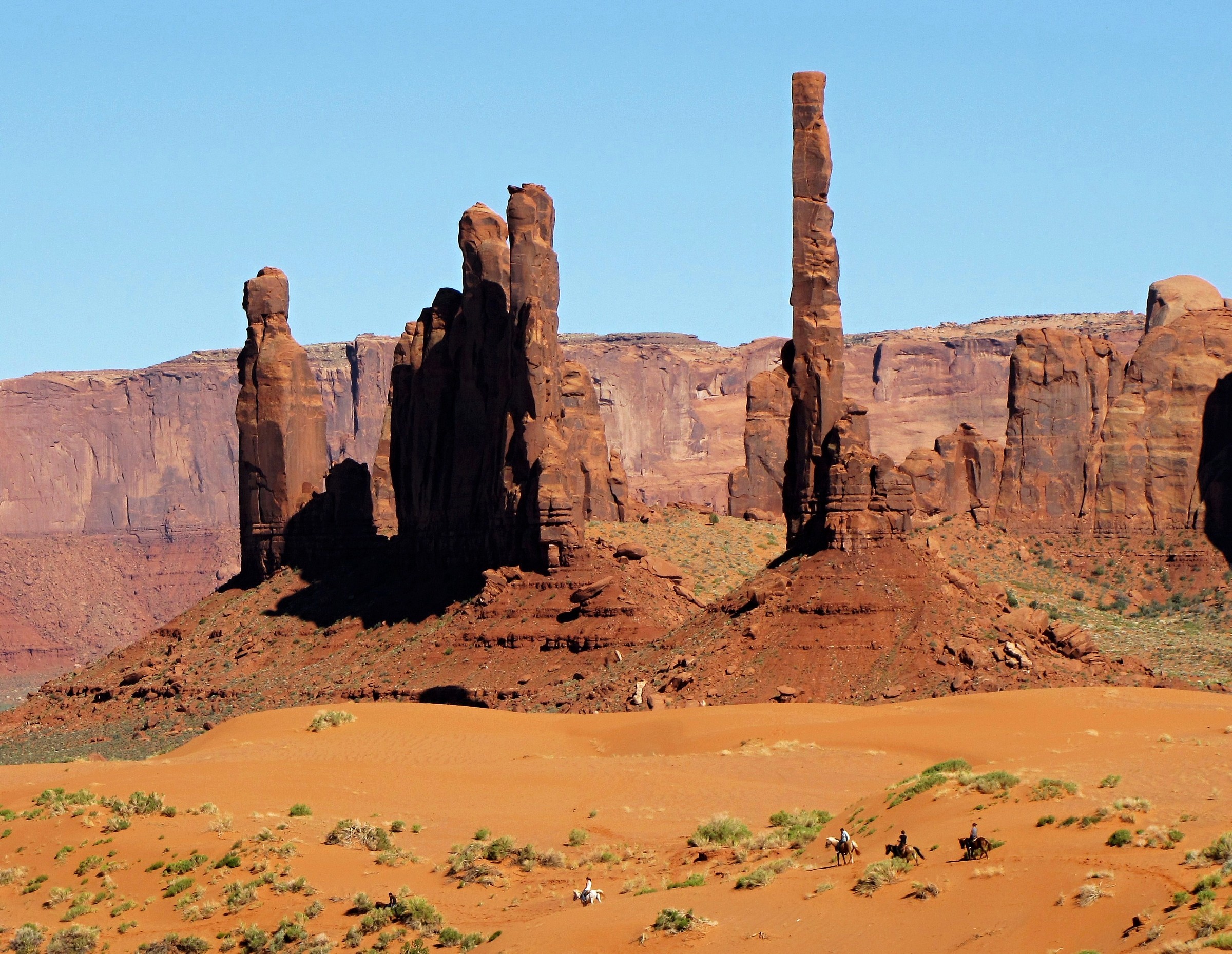 Tourists riding just below Totem Pole and Yei Be C