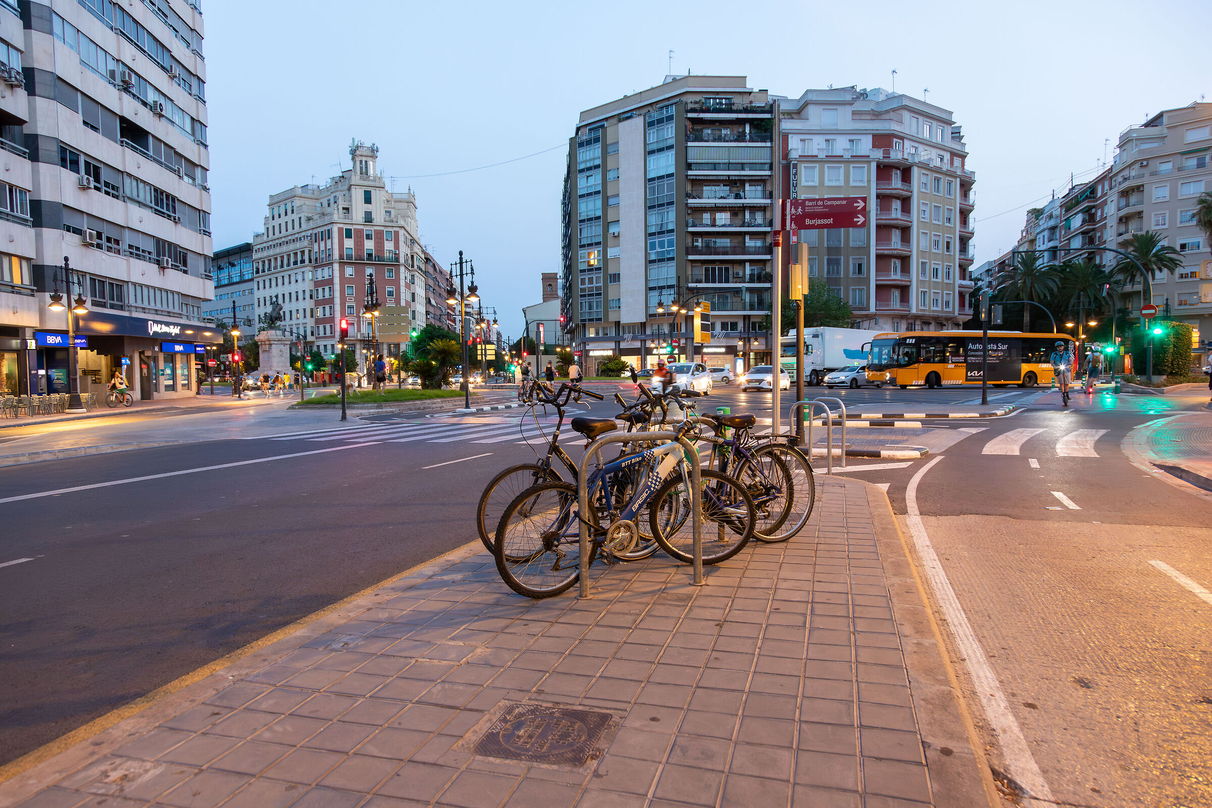 A cluster of bicycles at sunset