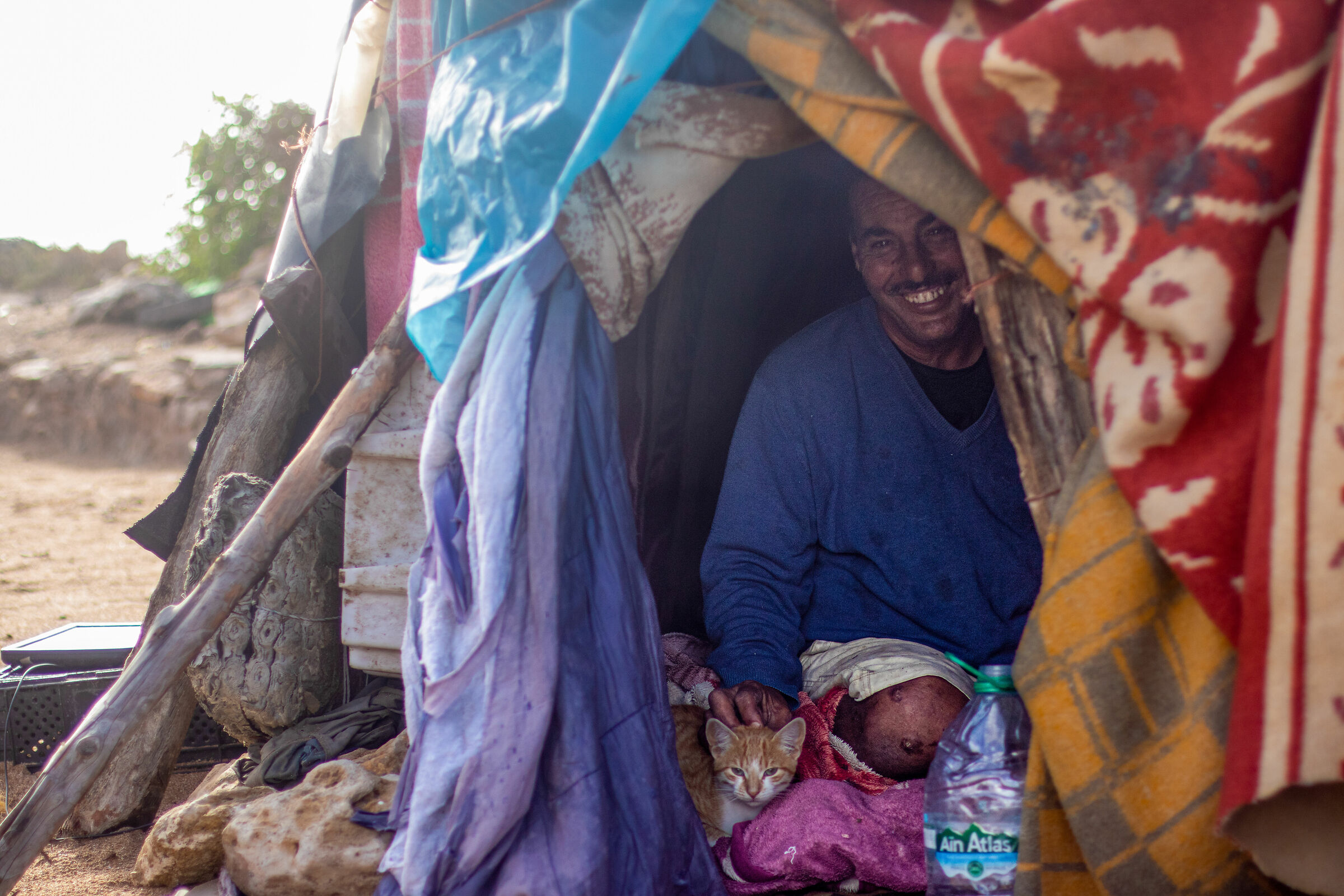 Fisher living on the beach with cat