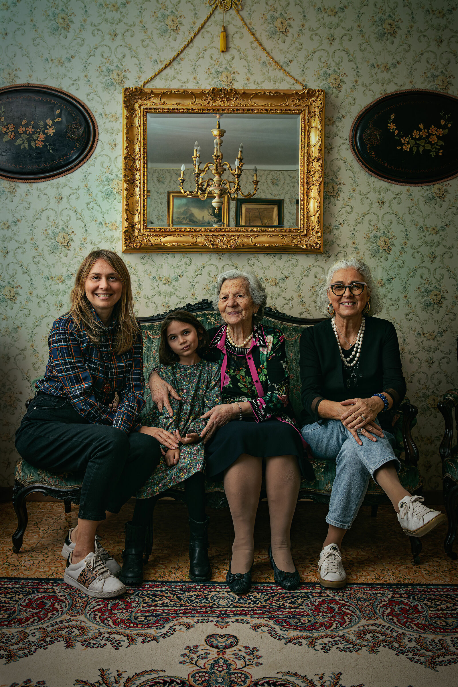 Four generations on a green sofa