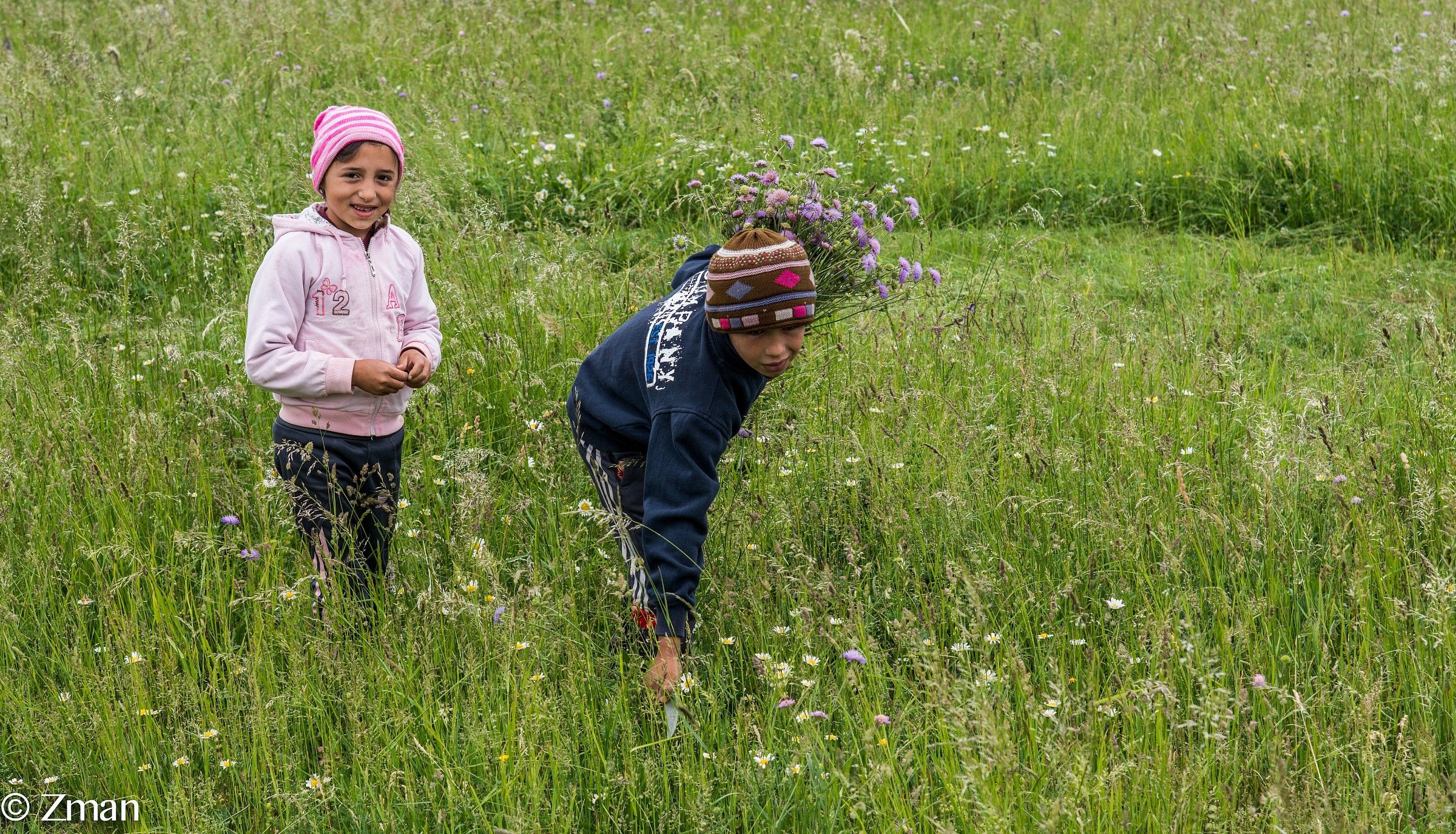 Gypsy Boy and Girl Picking Up Wild Flowers