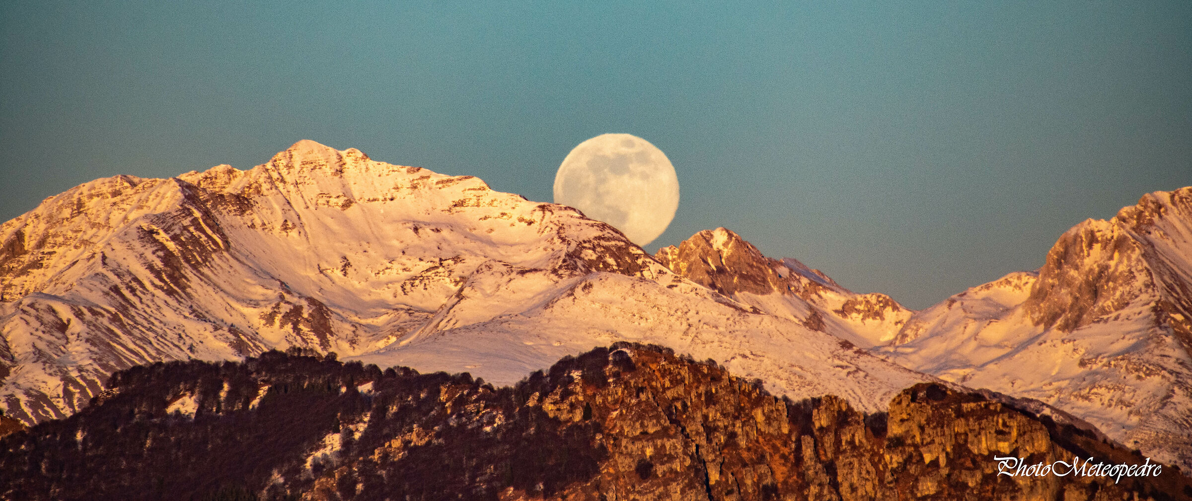 The moon rises from the mountain......
