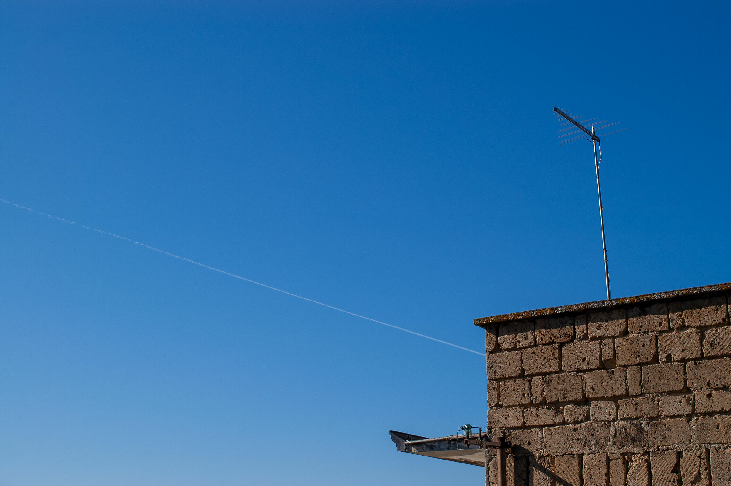 Clear skies with a contrail.