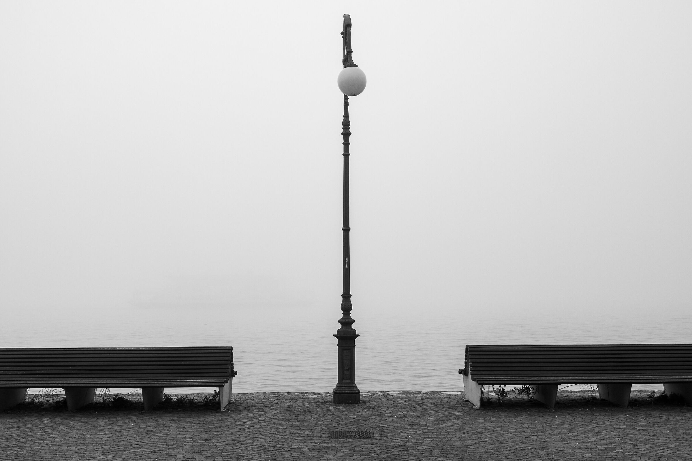 Lakeside promenade of Verbania Intra on a foggy morning