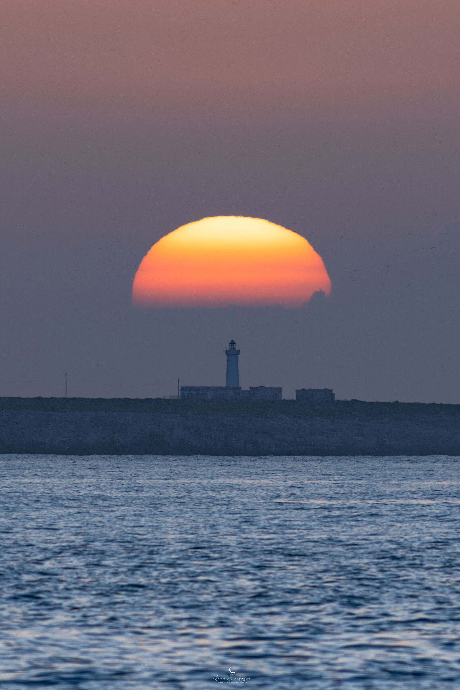 Sun umbrella over the Capo Murro Di Porco lighthouse