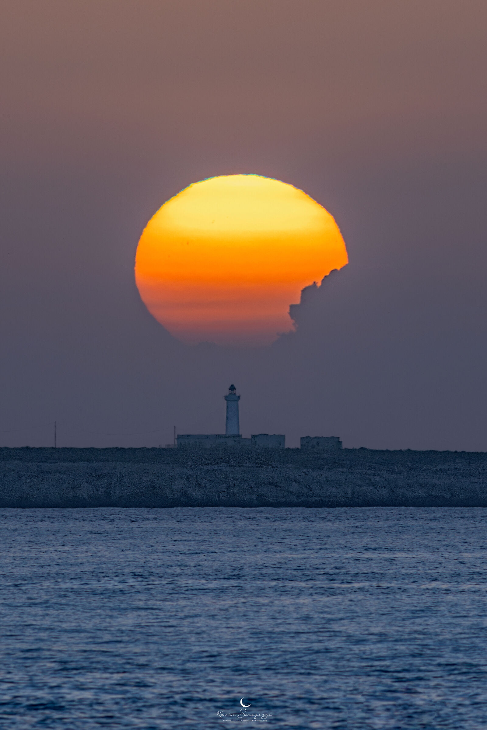Crunched sun over the Capo Murro Di Porco lighthouse