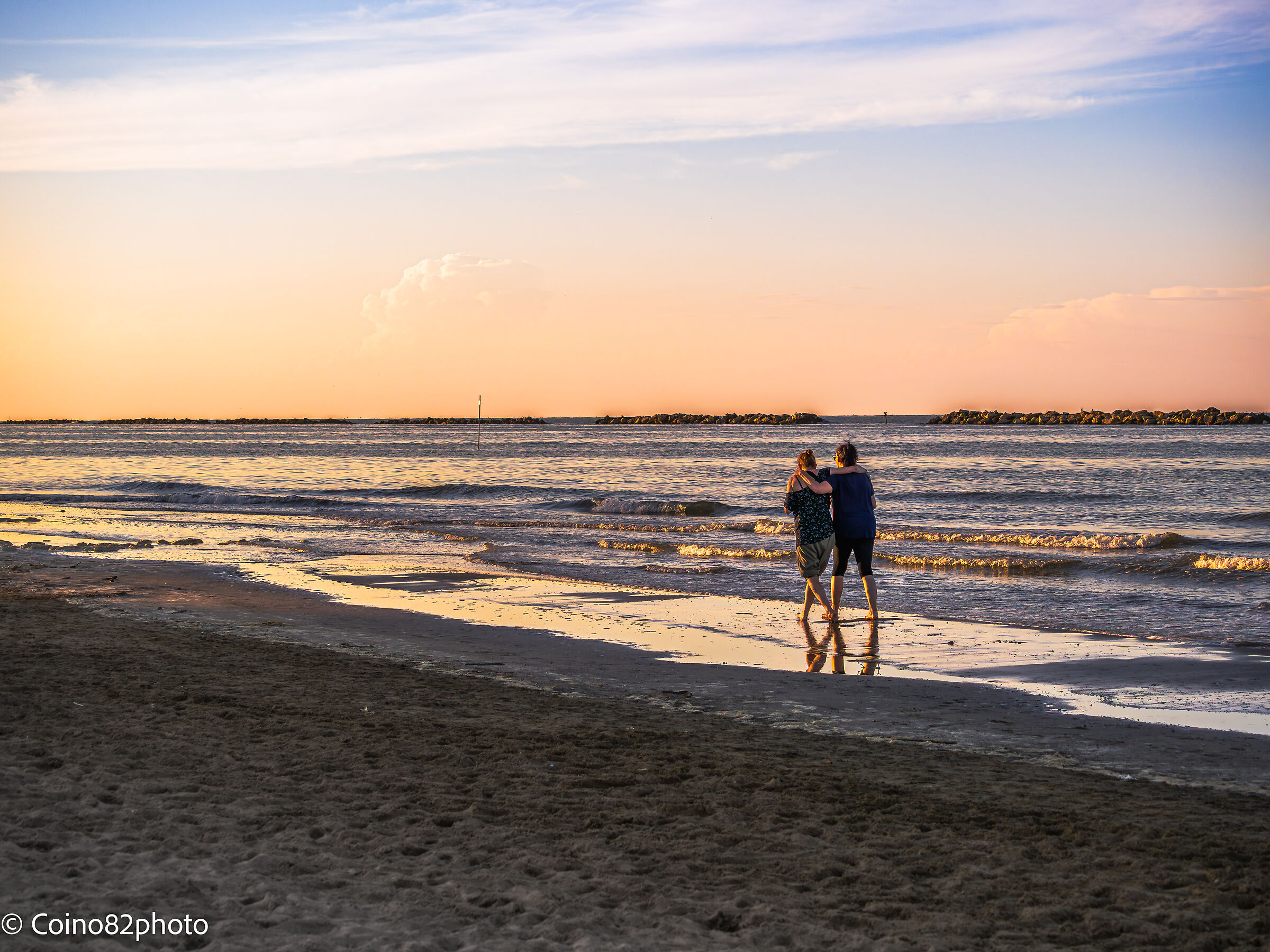 Sunset at the sea couple walking