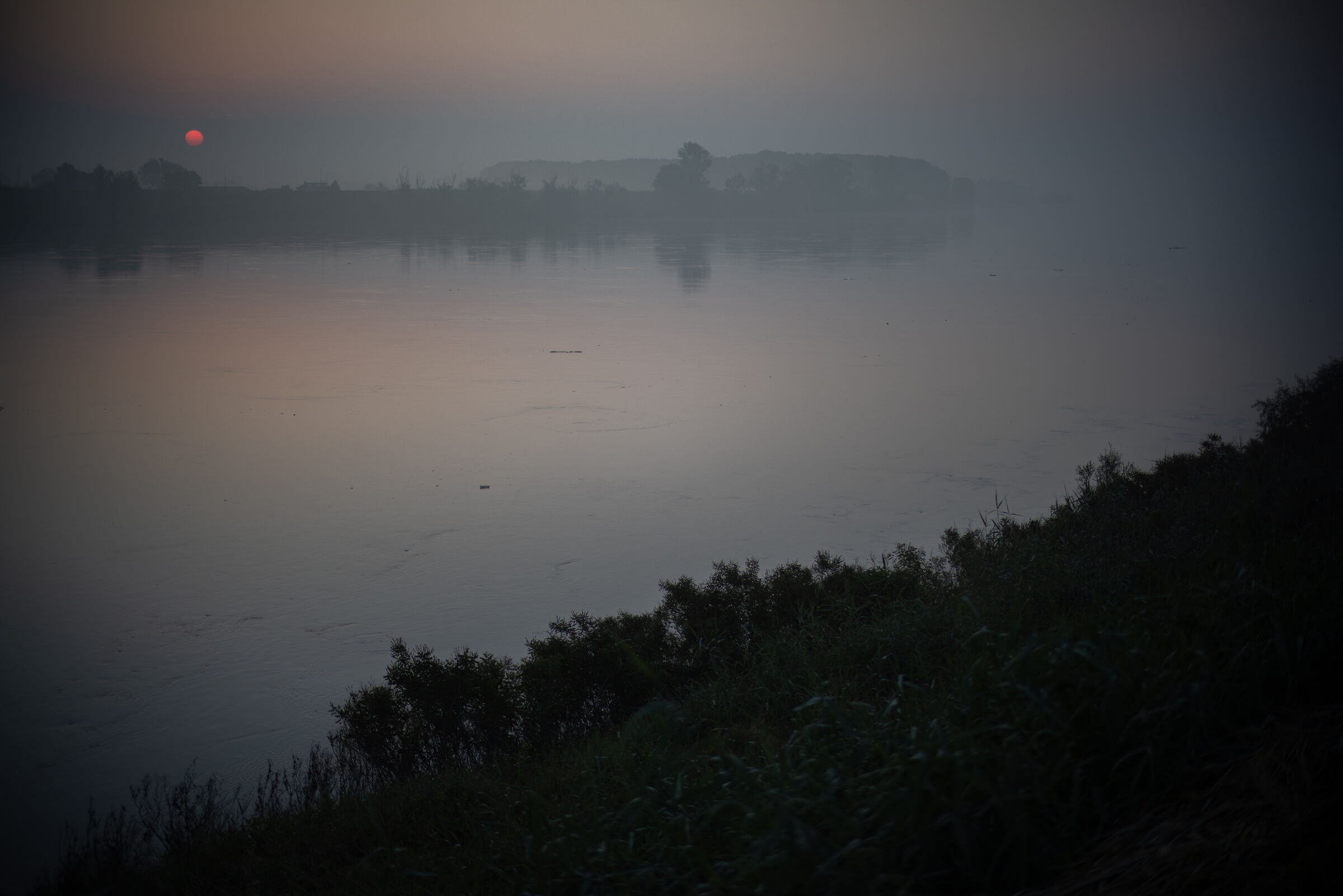 Slowly the river flows with the new day