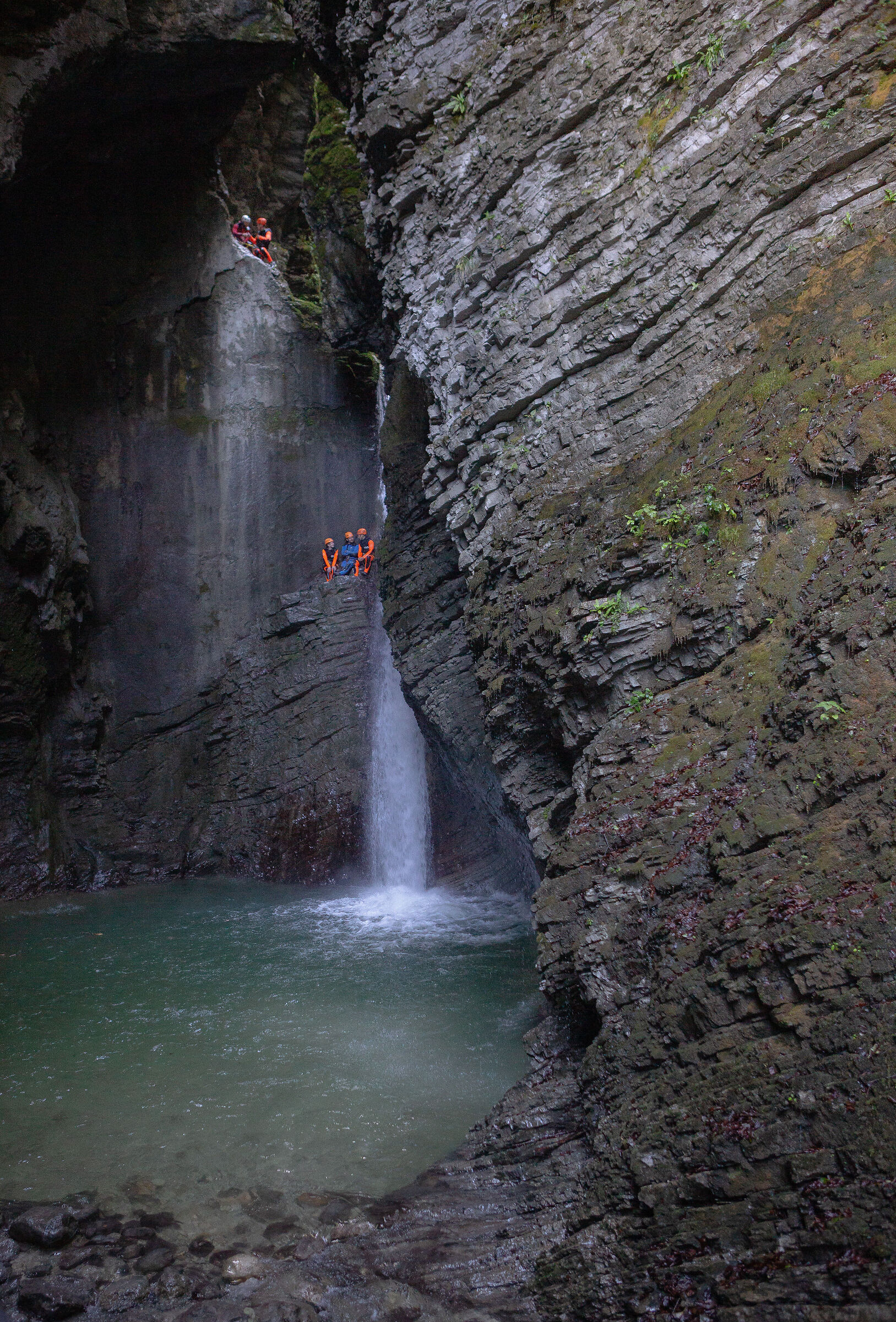 Speleologists in the waterfall