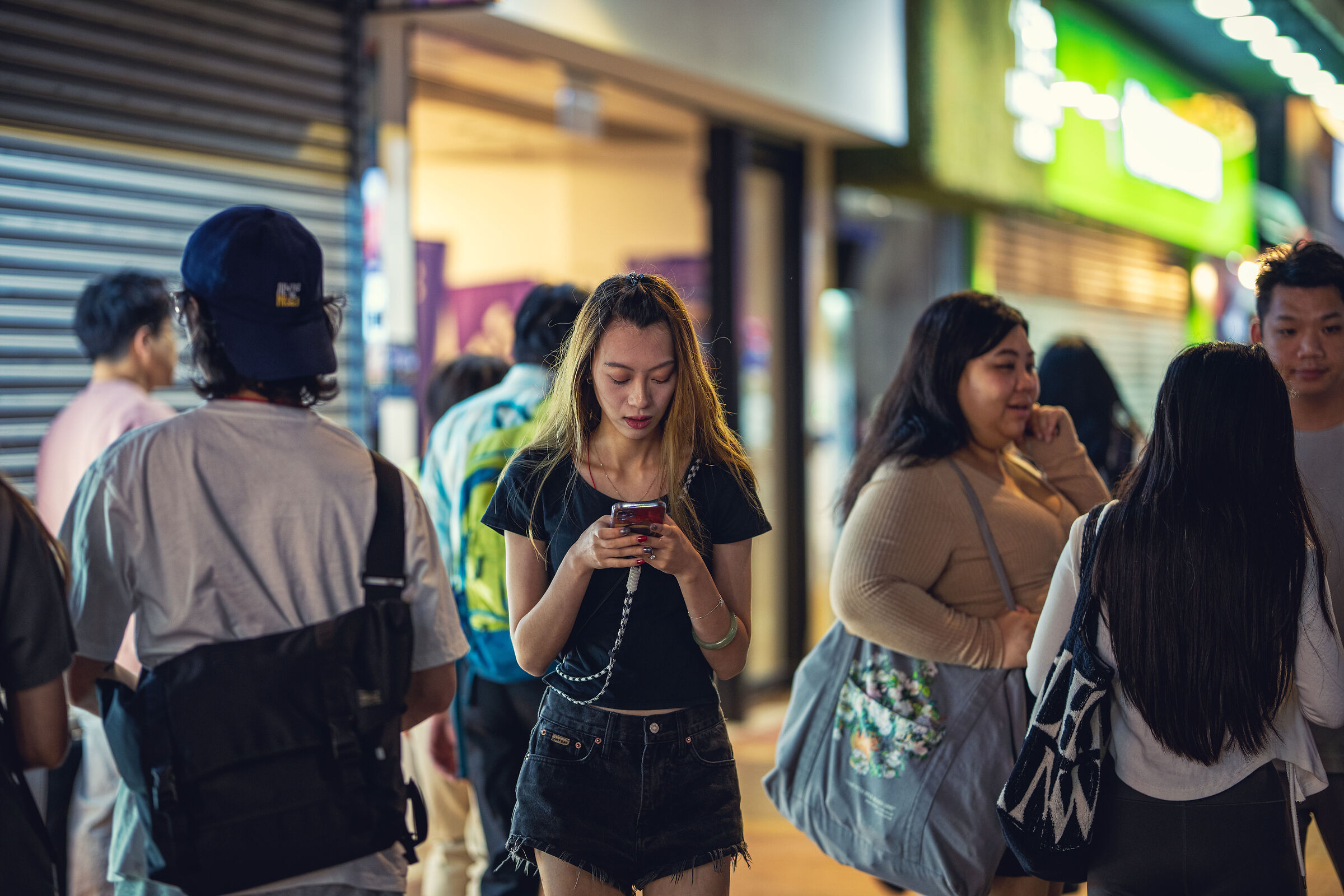 Girl texting in the crowd