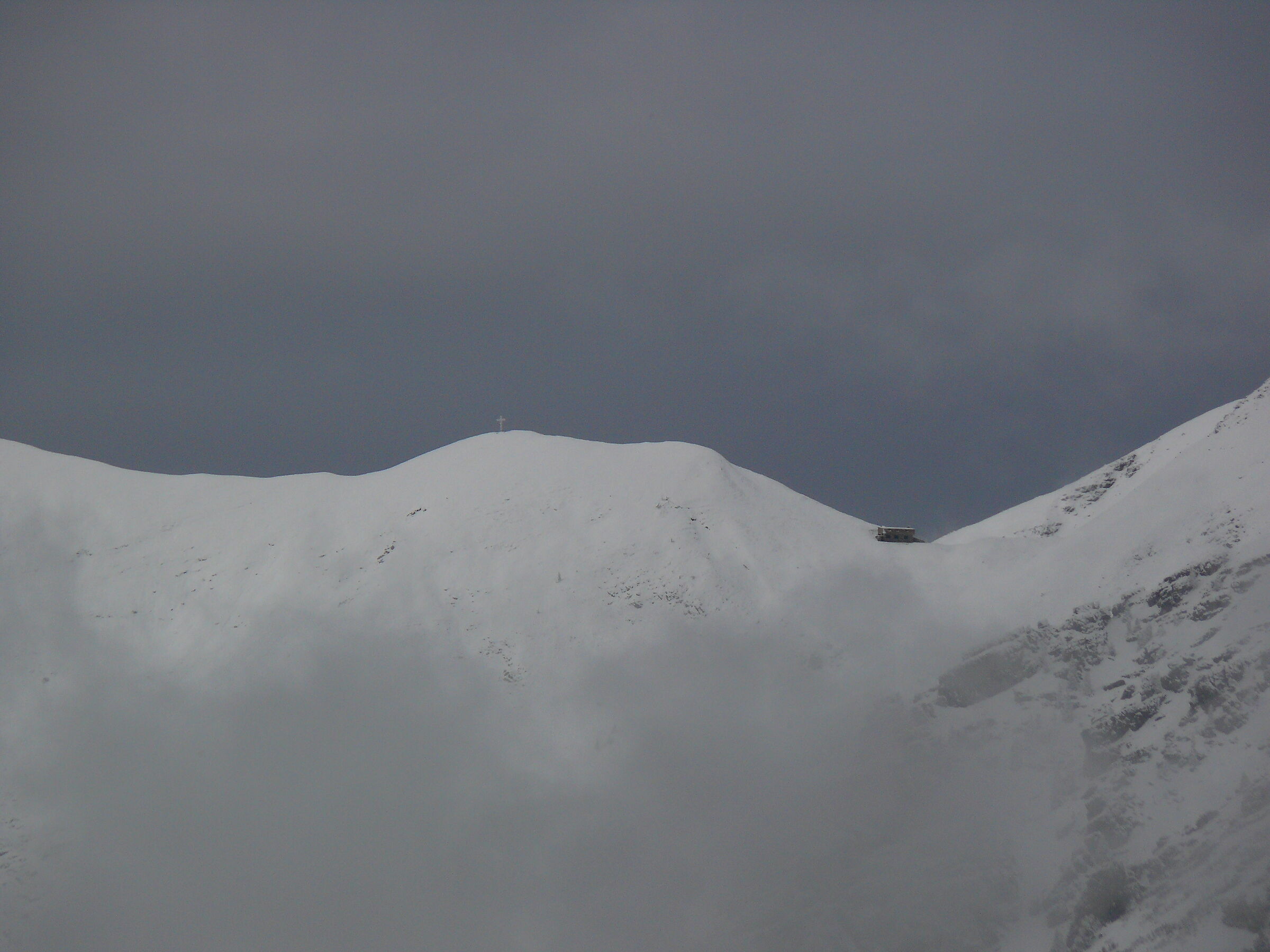 Maga bivouac and cross at the top left