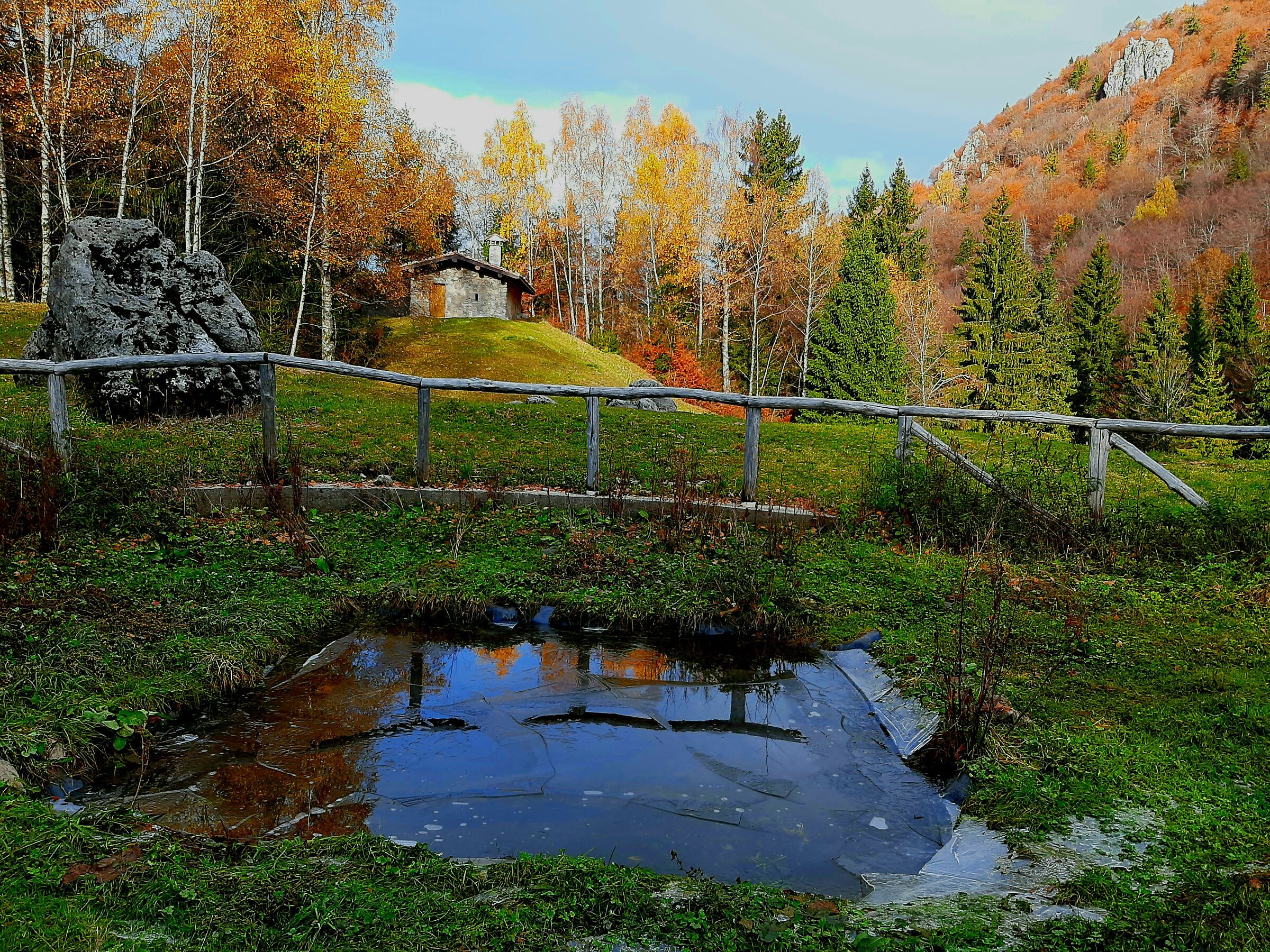 Stable and puddle in autumn