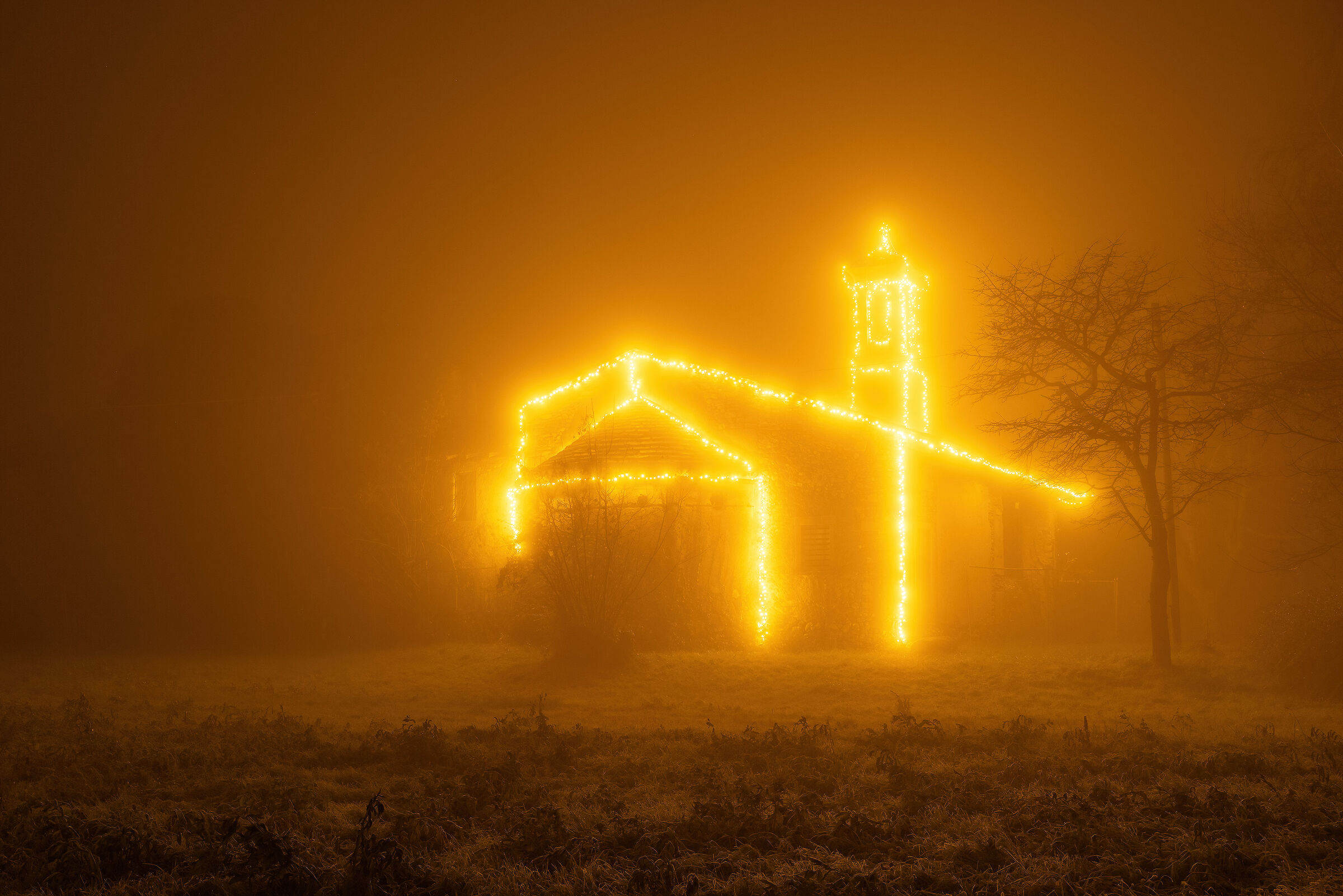 The small church of San Siro in the fog