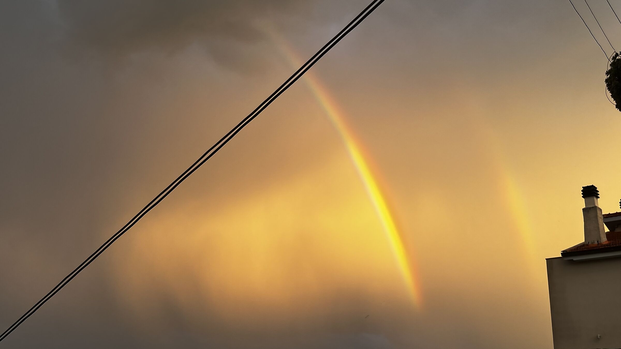Rainbow among golden clouds