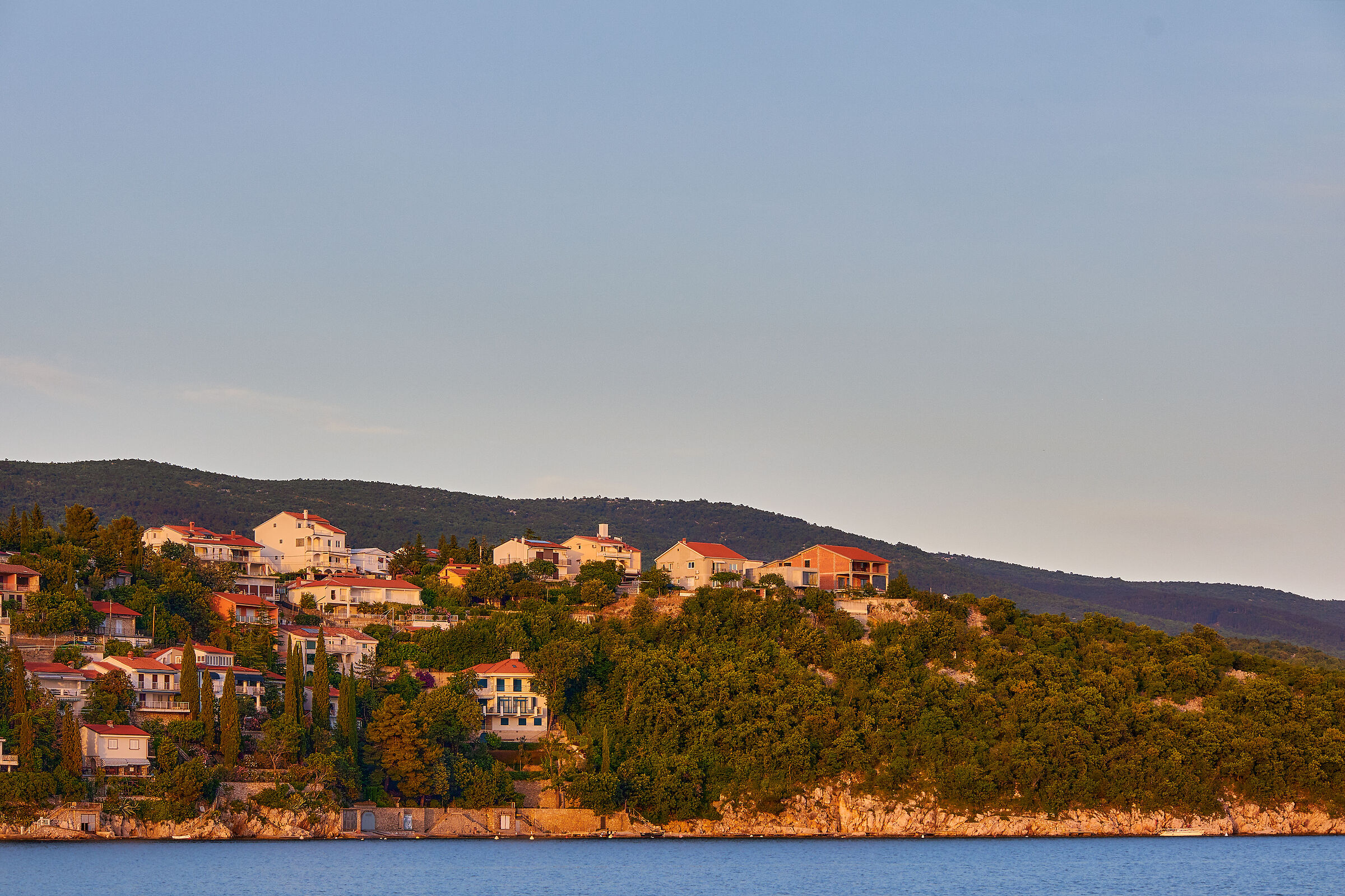 sunset over houses in Pla?a Haviš?e, Croatia