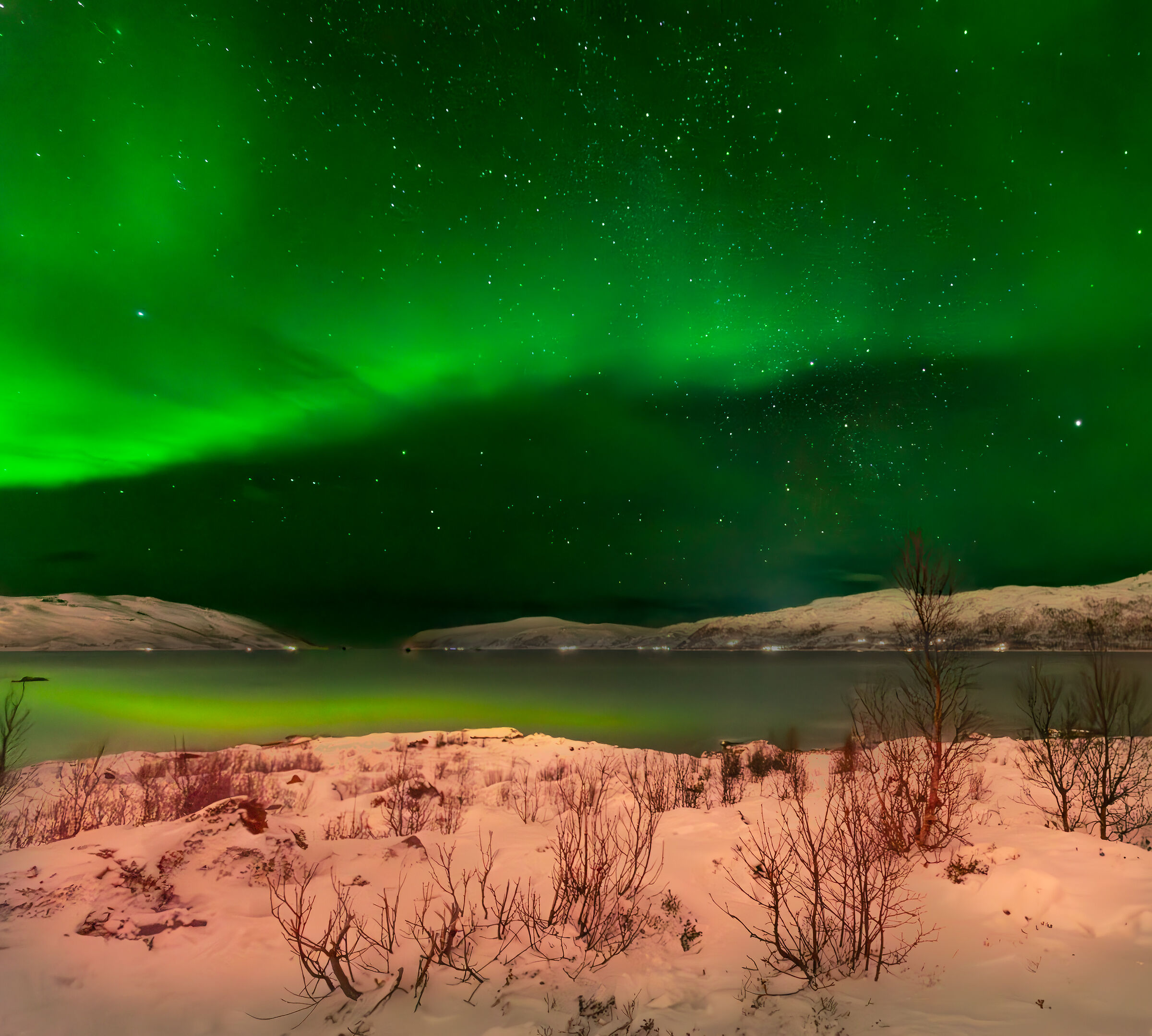 Northern lights with reflection on the fjord